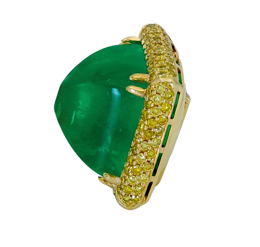 A rare piece of jewelry showcasing a sugarloaf cabochon emerald, set in a micro-pave yellow diamond mounting made in 18k yellow gold. Foldable bale.
AGL certified pyramidal cabochon weighing 30.07 carats and of Colombian Origin.
Diamonds weigh 1.79