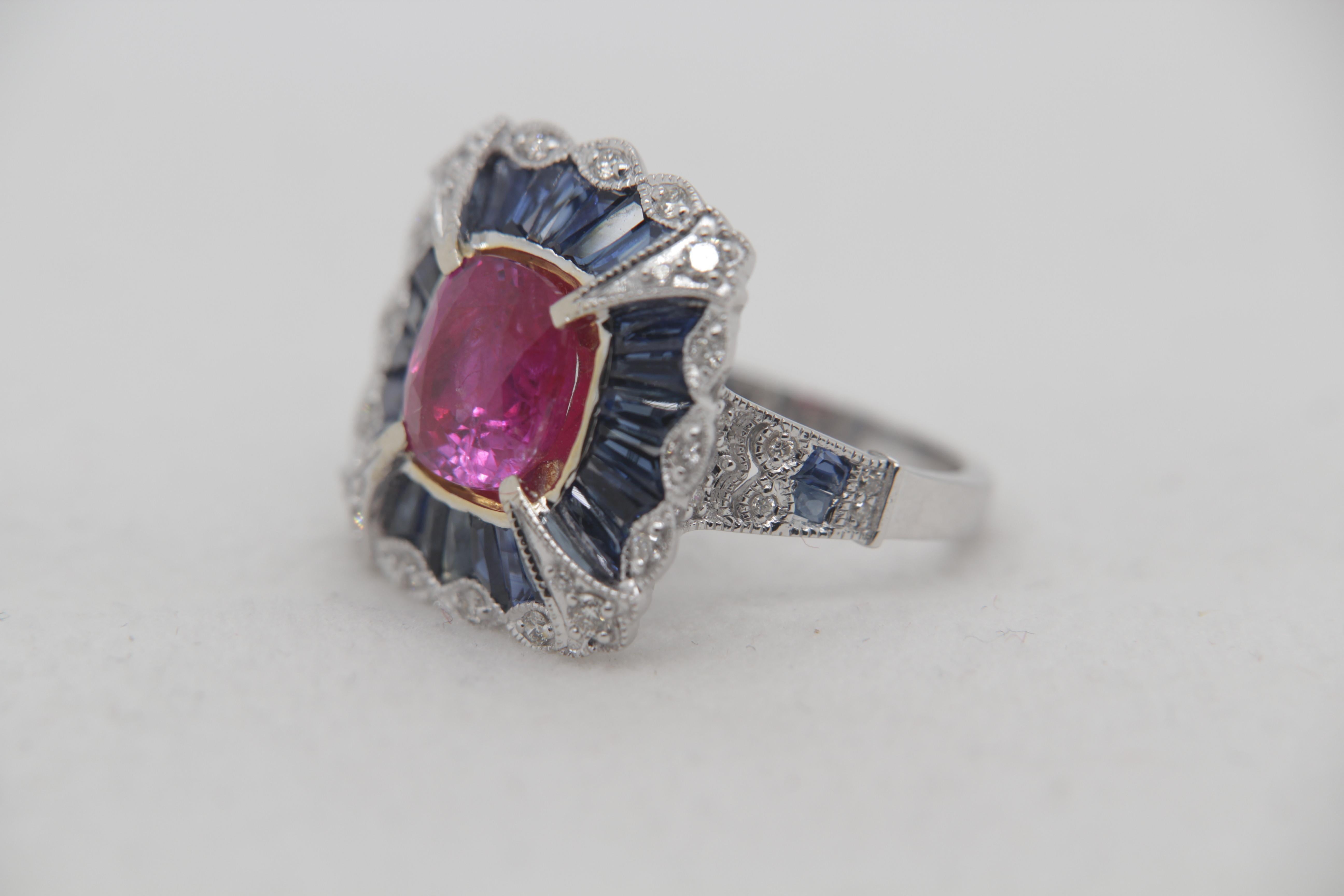 A brand new 3.11 carat Burmese ruby ring mounted with diamonds in 18 Karat gold. The ruby is of weight 3.11 carat and is certified by AGL (Thai) as natural, no heat, and 'Purplish Red'. The total diamond weight is 0.29 carat and blue sapphire weight