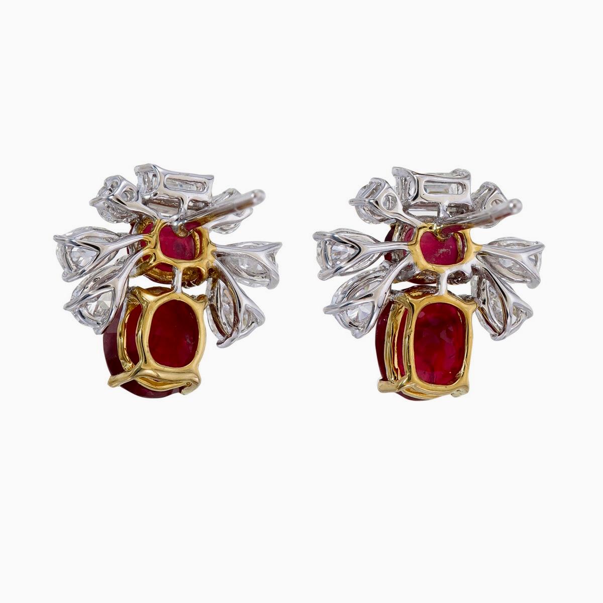 A brand new pair of elegant ruby and diamond earrings made by Rewa jewels in 18 karat white gold.

There are 2 centre pieces of Burmese ruby no heat, pigeon blood in colour weighing approximately 2.34 carat in total. The smaller 2 rubies weighing
