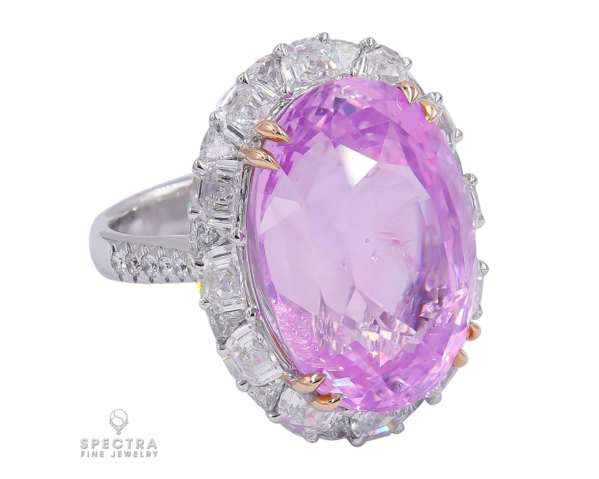 Pink is one of the rarest sapphire colors, caused by trace elements of chromium inside the corundum crystal, the same which colors a ruby. This Contemporary Pink Sapphire Halo Ring, made in the 21st century, would be stunning as a cocktail ring or