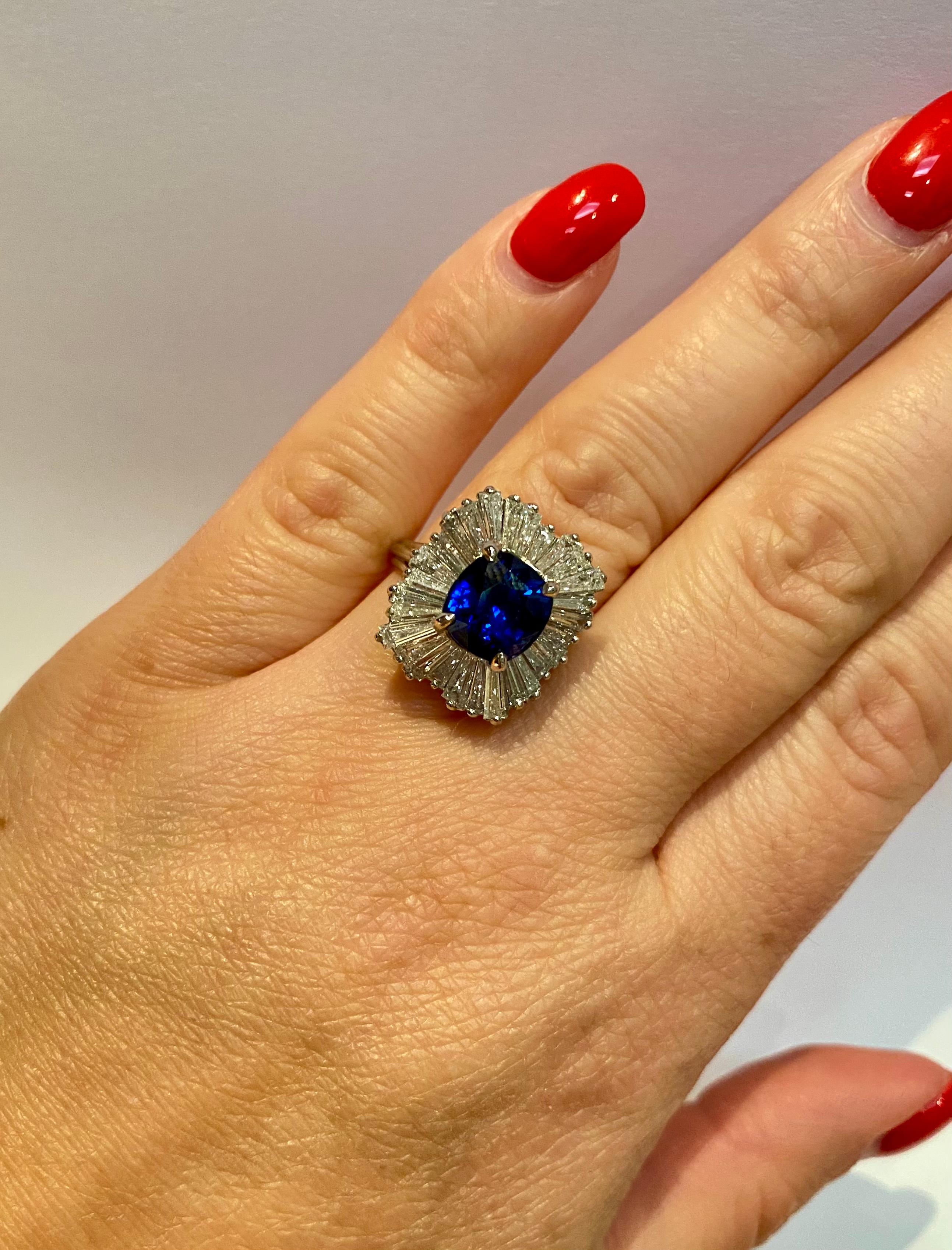 Finley crafted beautiful cocktail Platinum Diamond Ring with Cushion cut Blue Sapphire in the center weighting 3.76 carats. 
Approximate weight of baguette cut diamonds in the ring is 2 carats, size 675.
The ring could be resize to a smaller or