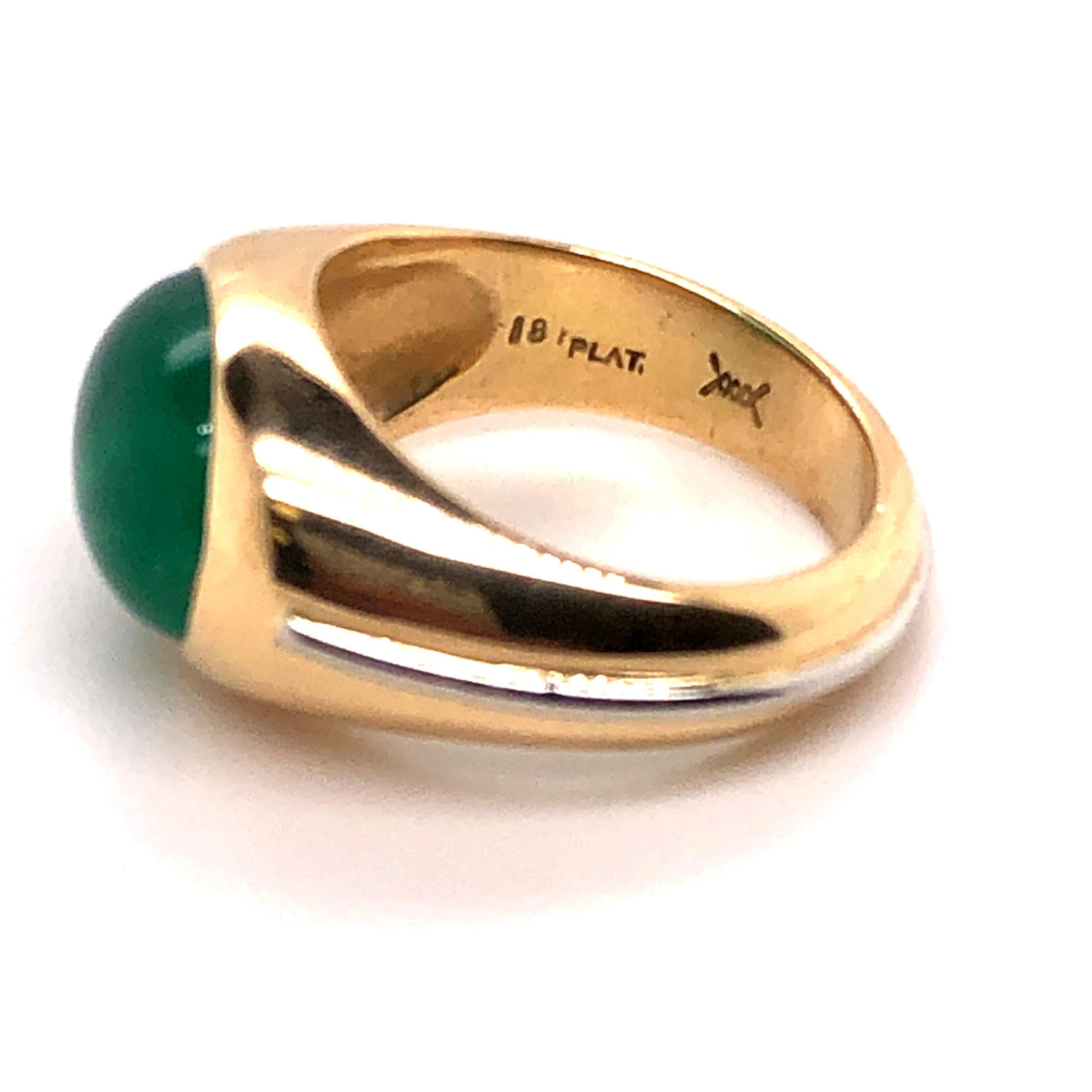 18kt yellow gold ring with a platinum racing stripe on the band. This ring contains one center bezel set 5.11 natural AGL certified Colombian emerald cabochon cut emerald. AGL is a world renowned gemological laboratory. This ring comes with the AGL