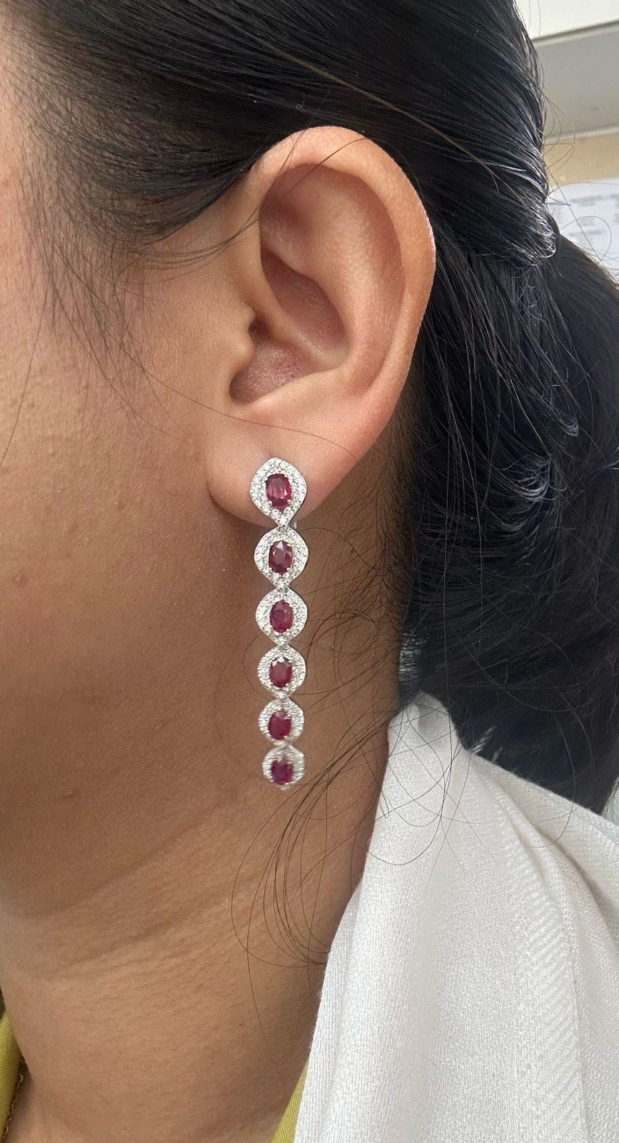 A pair of fine timeless ruby and diamond earrings made in 18 Karat gold. This pair of earrings embraces minimalism with its simple design while still displaying elegance; a great fit for lifestyle wear.

- There are 12 center oval Pigeon Blood