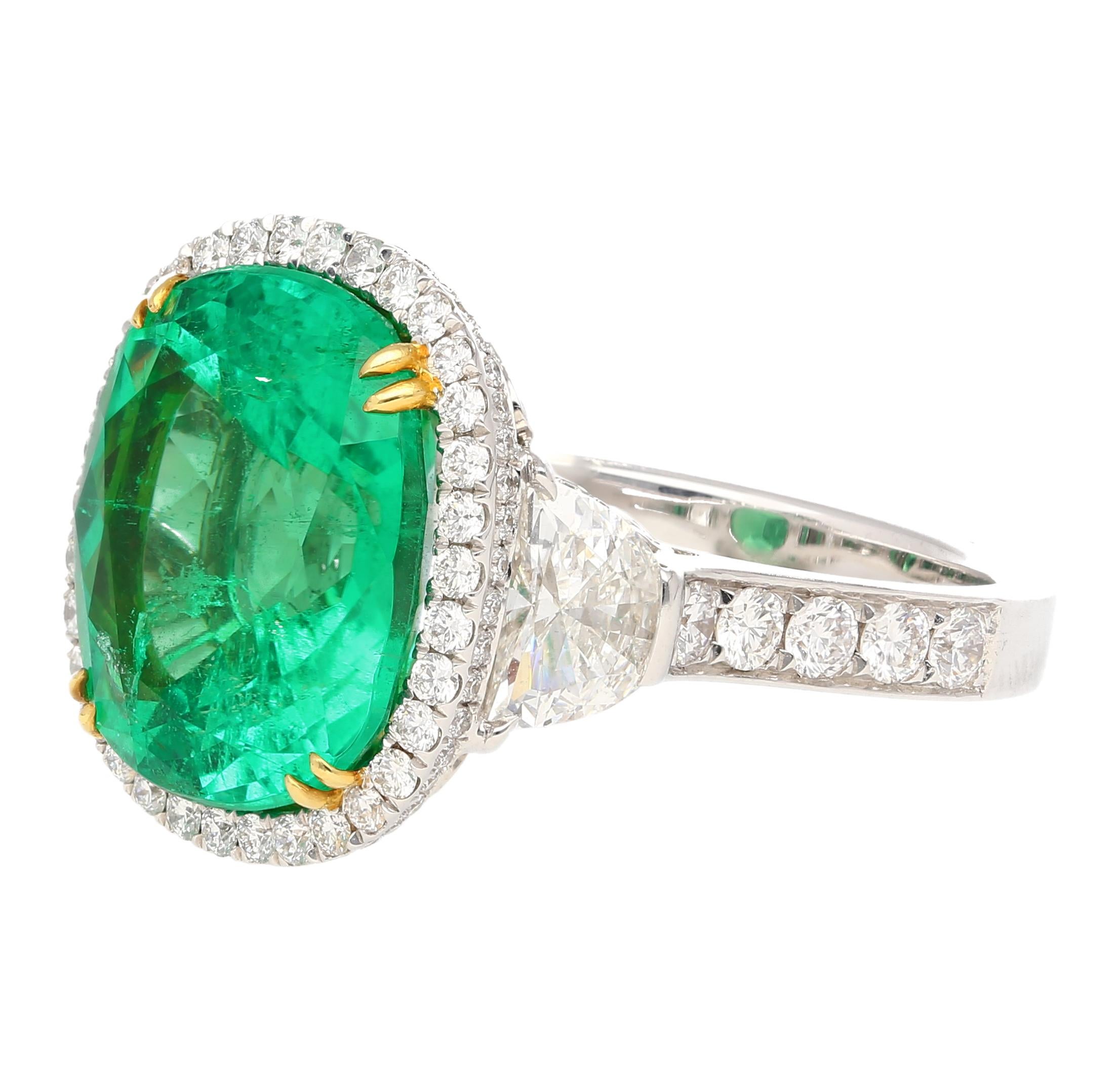 AGL Certified 7.36 carat no oil Colombian Emerald ring. Featuring 2 half moon-cut diamond side stones with 106 round cut diamonds mounted on the shank. All set in an 18 karat solid gold ring setting. 18K white gold shank with yellow gold prongs.