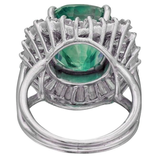 Centering a cushion-cut colombian emerald, framed by tapered baguette diamonds.

Emerald weighing approximately 7.63 carats
Diamonds weighing a total of approximately 1 carats
Size 7
Platinum
Accompanied by AGL report 