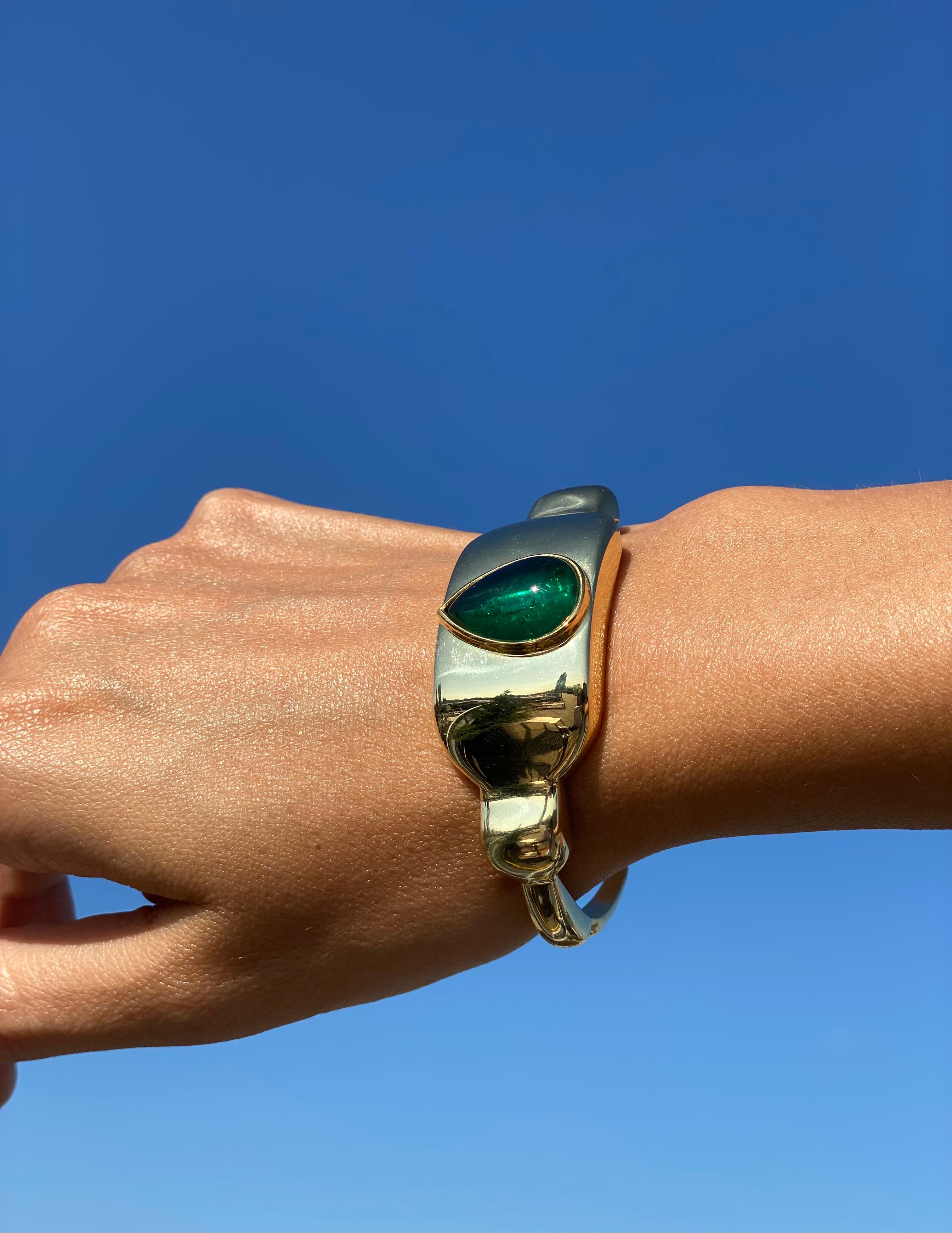  

This spectacular solid gold and emerald cuff was hand carved in Paris by Victoria Pourcines and subsequently set and finished here in California by Kate Lee Short. It features an AGL certified minor oil 8 carat Colombian pear shaped emerald