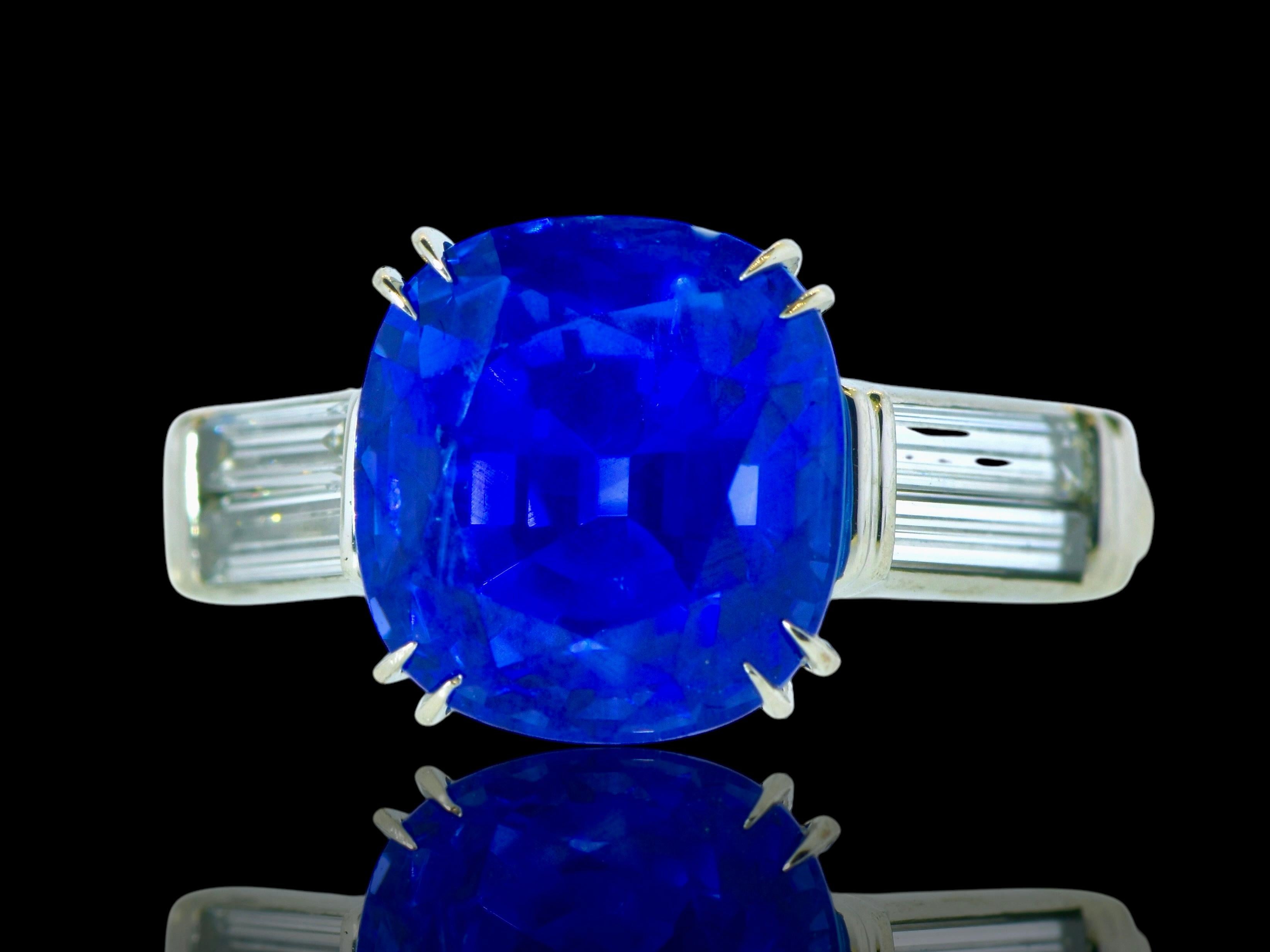 Very fine royal blue large sapphire that has been examined by the leading American gem laboratory for colored stones: A.G.L., American Gemological Laboratory.  Set in platinum and flanked by 4 long baguette cut diamonds, measuring 7.3 mm.  These