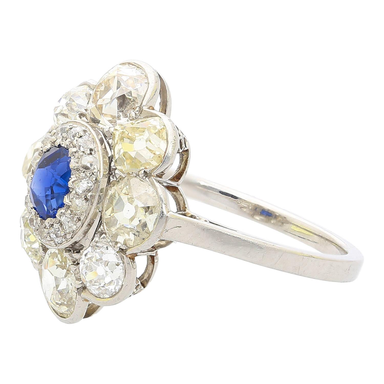 Introducing this vintage retro era oval cut Blue Sapphire and old euro cut diamond halo ring, set in platinum. This historic ring features an AGL certified 0.50 carat Blue Sapphire of Burmese origin and no heat treatment. Adorned with over 4 carats