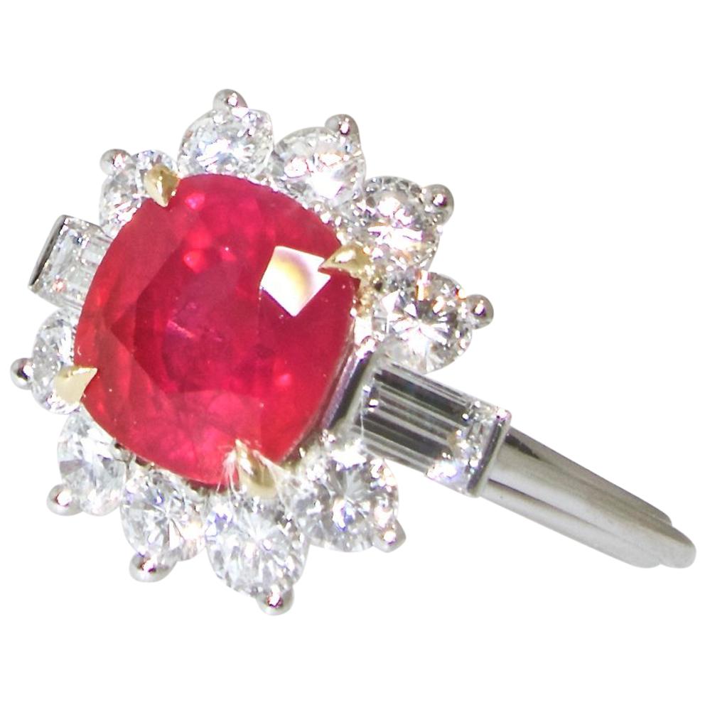 A.G.L. Certificate accompanies this bright red Burma ruby which weighs 3.08 cts.  Its is a natural, heated, fine ruby which is accented with  12 diamonds weighing .78 cts.  This well matched and well cut diamonds are near colorless and very slightly