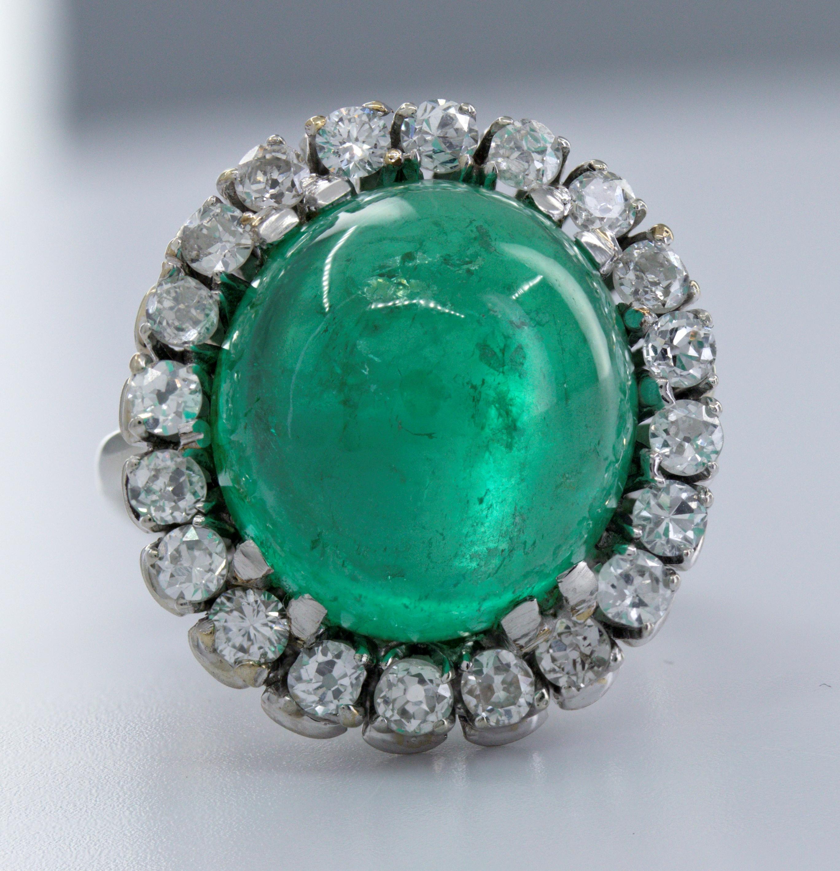 Featuring (1) oval emerald cabochon, 12.60 cts., accompanied with an AGL Report 1132021, dated 26 May 2023, stating Colombian origin and traditional, minor to moderate enhancements, surrounded by (20) old European-cut diamonds, 1.00 ct. tw., SI-I,