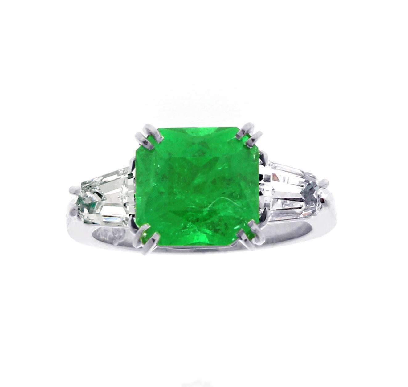 From Pampillonia Jewelers, a gem Zambian square emerald with shield cut diamonds set in a handmade platinum ring.
♦ Designer: Pampillonia
♦ Metal: Platinum
♦ Zambian Gem Emerald =2.84  AGL only minor  traditional clarity enhancement
♦ 2