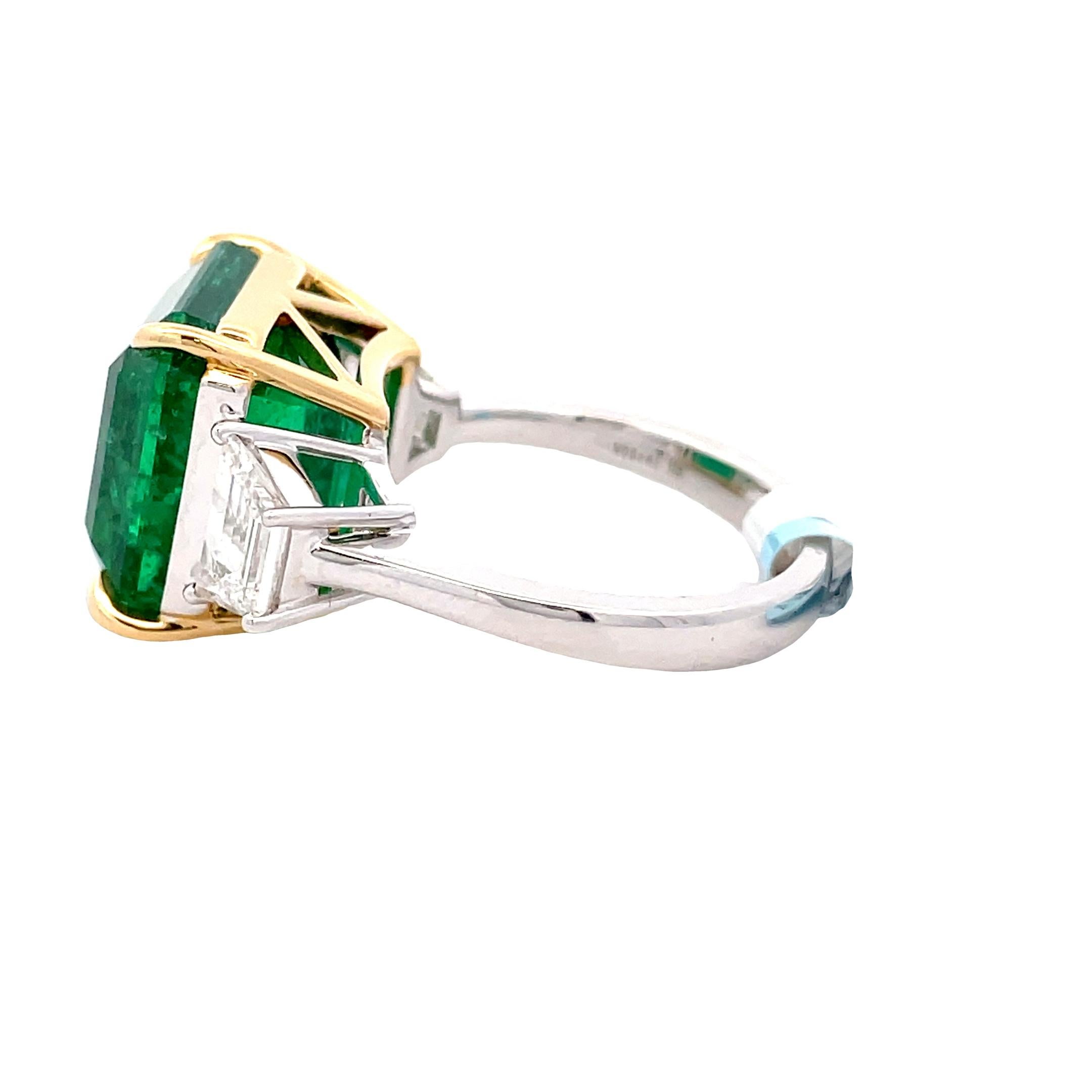 Embrace elegance with our AGL certified 13.14 carat emerald octagon and white diamond trapez 1.18 carat 18KW ring. This stunning piece exudes luxury and sophistication, featuring a mesmerizing emerald centerpiece complemented by sparkling white