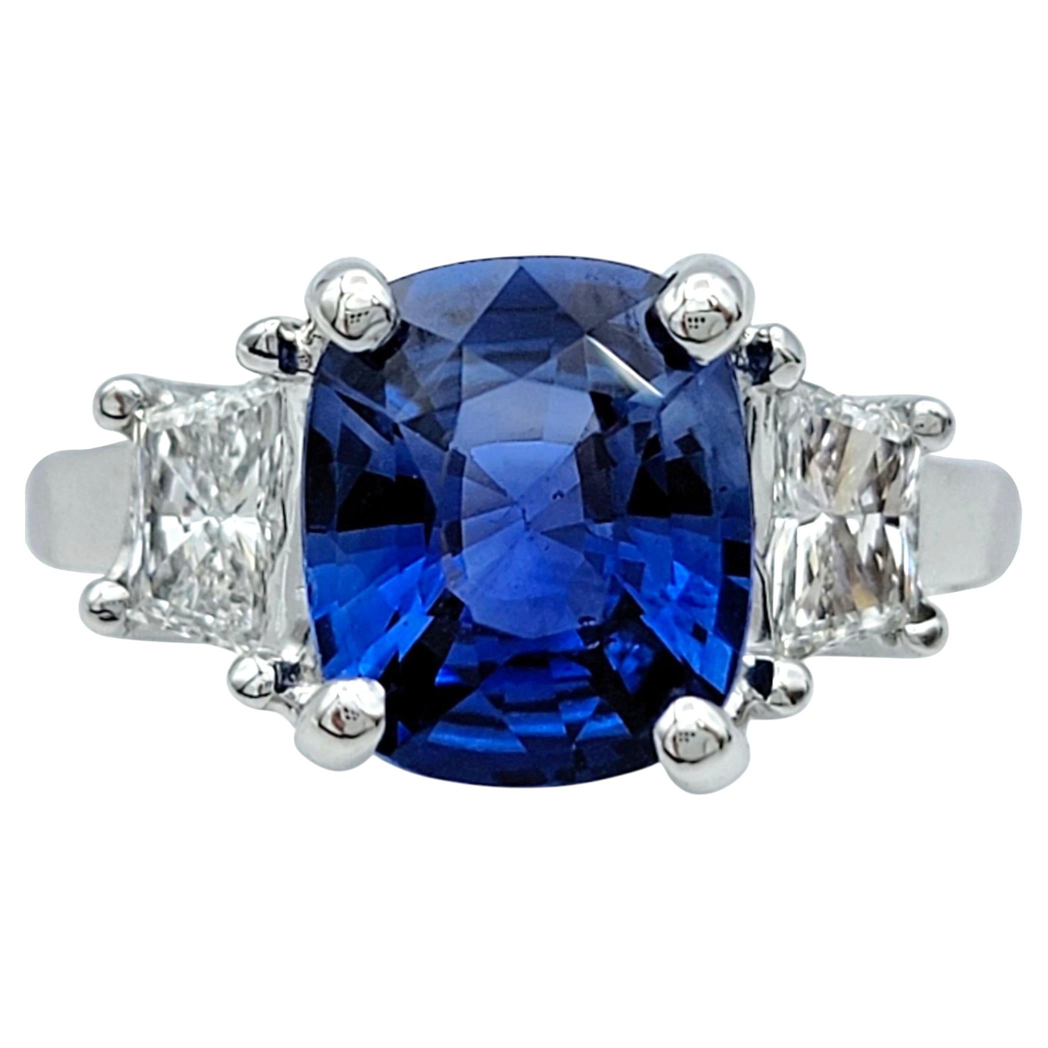 Ring Size: 5

This striking ring showcases a stunning cushion modified mixed-cut Madagascar sapphire, its deep blue hue exuding elegance and rarity. The sapphire’s natural transparency allows light to dance within its facets, creating a mesmerizing