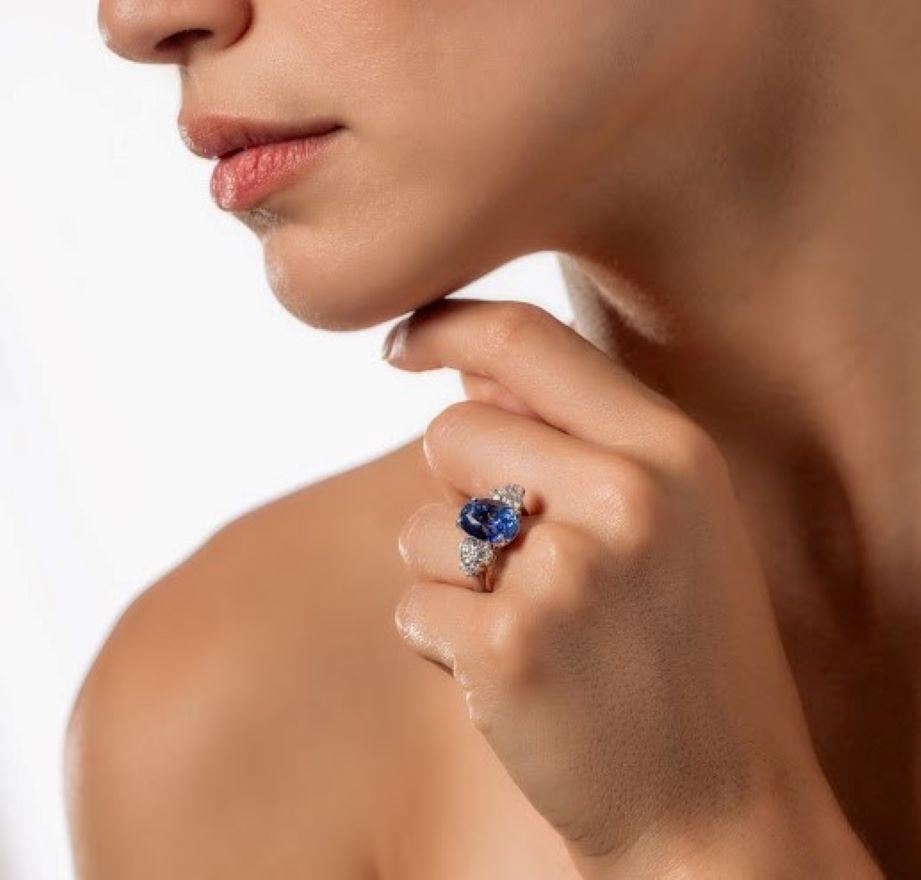 An oval mixed cut American Gemological Lab and Colombo Gemological Lab certified natural no heat Ceylon (Srilanka) 8.01 carat blue sapphire and diamonds ring in 18k white gold.
Sapphire is medium dark tone, strong saturation, blue hue. Measured