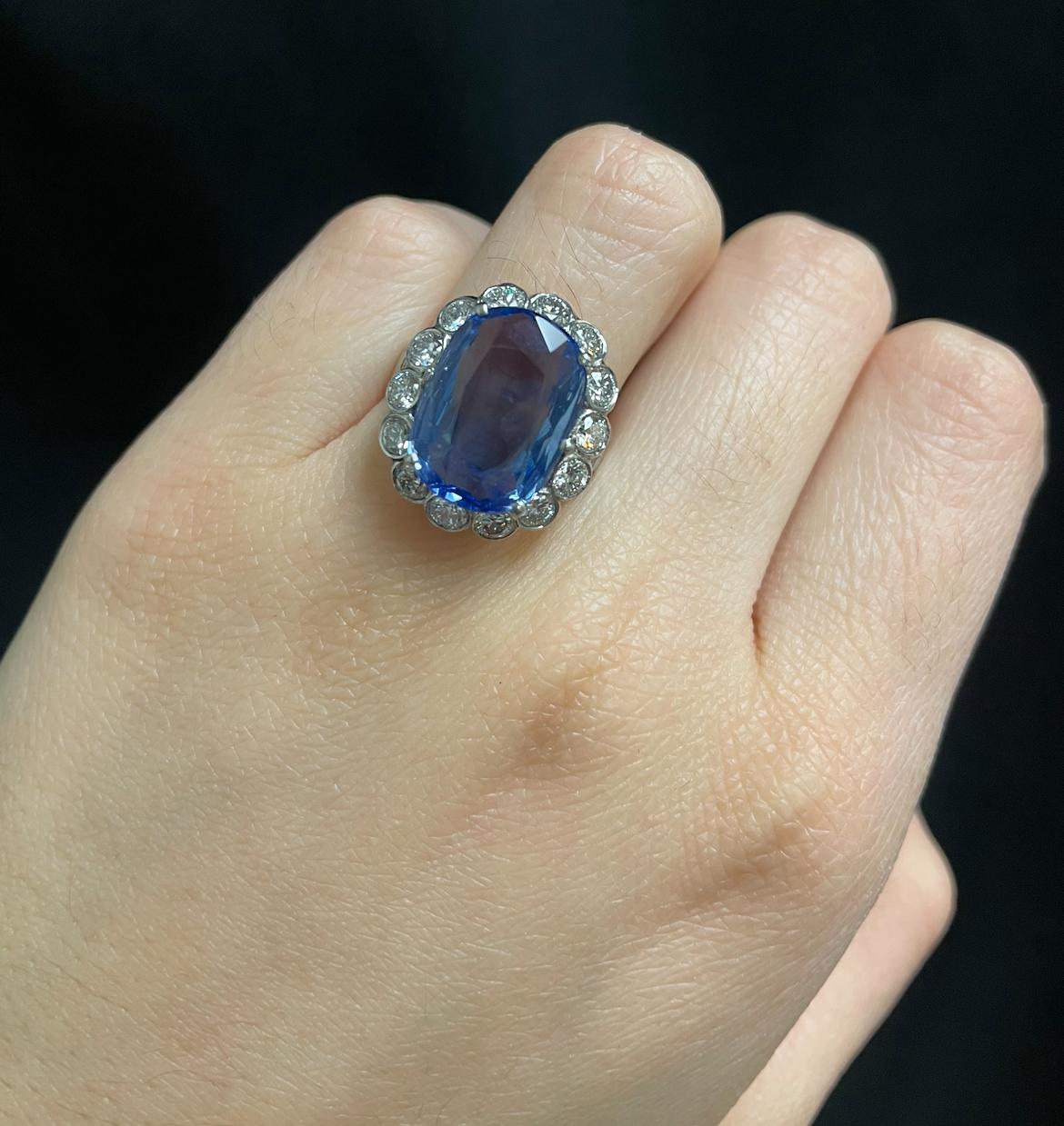 AGL Certified Natural Oval Sapphire and Diamond Ring

A white gold ring set with a natural oval cut sapphire adorned with 14 round cut diamonds

Sapphire Weight: 11.23 carats
Accompanied by an AGL report stating the sapphire is unheated and of