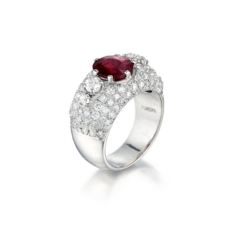 A vibrant platinum, ruby and diamond ring featuring an oval cut red 2.22 carat unheated Thai ruby (AGL certified), surrounded by old European- and single-cut diamonds weighing a total of approximately 1.85 carats, most with H-J color and VS-SI