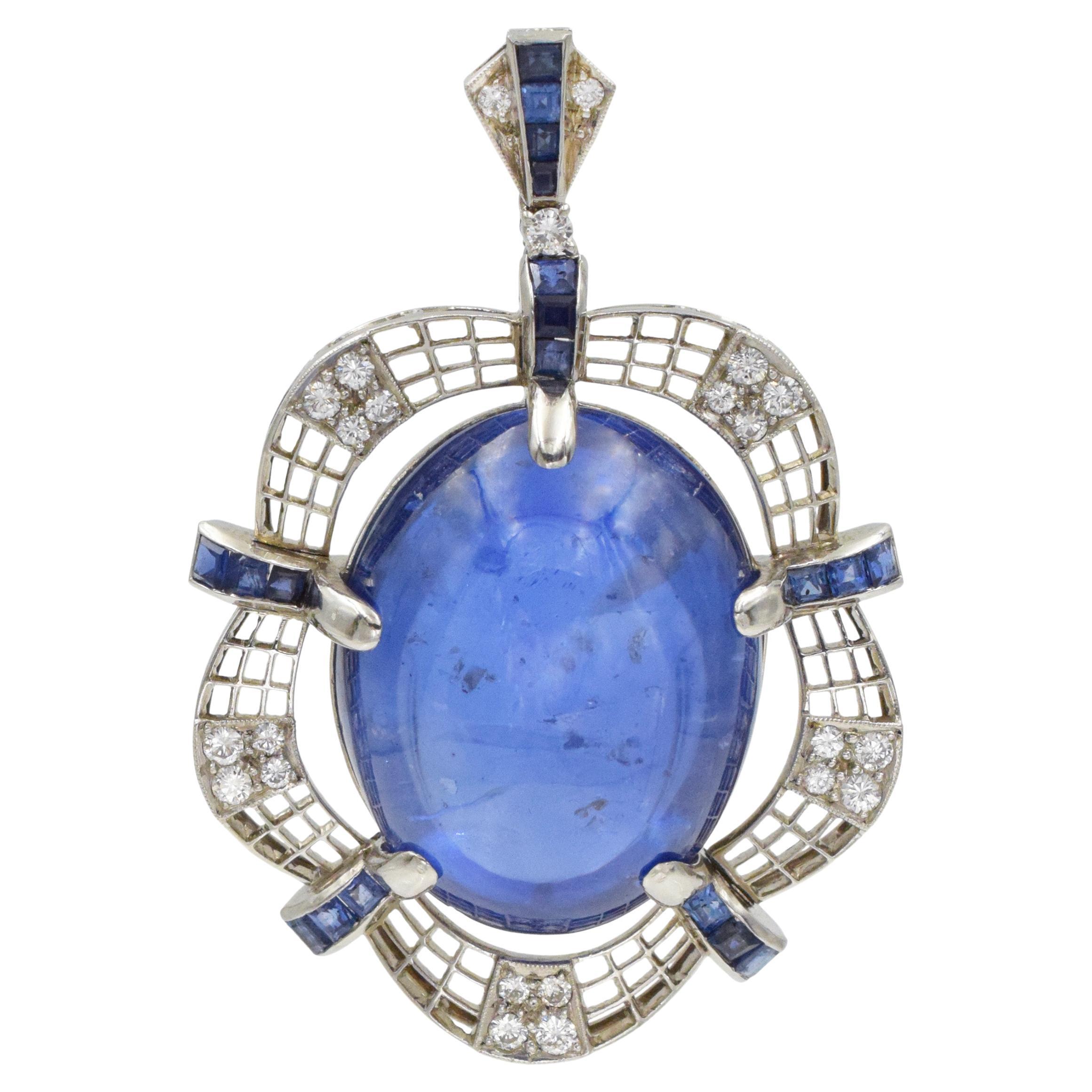 Impressive Sapphire pendant!
Center of this pendant is set with oval double cabochon-cut sapphire with weight of 92.04ct, accented with 19 square shaped sapphires with total weight of approximately 1.50ct, and 23 round brilliant cut diamonds, with