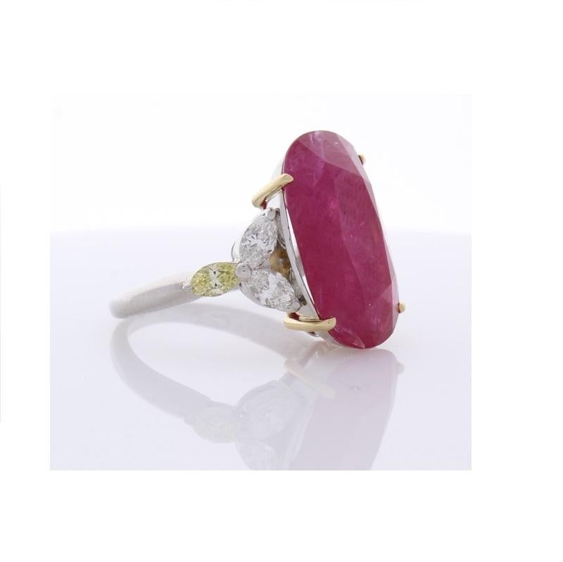 This is a statement ruby ring. The simple and beautiful design of this ring showcases a gorgeous 12.22 carat, AGL certified ruby. The color is blood-red and is evenly distributed through the gem. It is accompanied by 1.08 carats of cape-colored