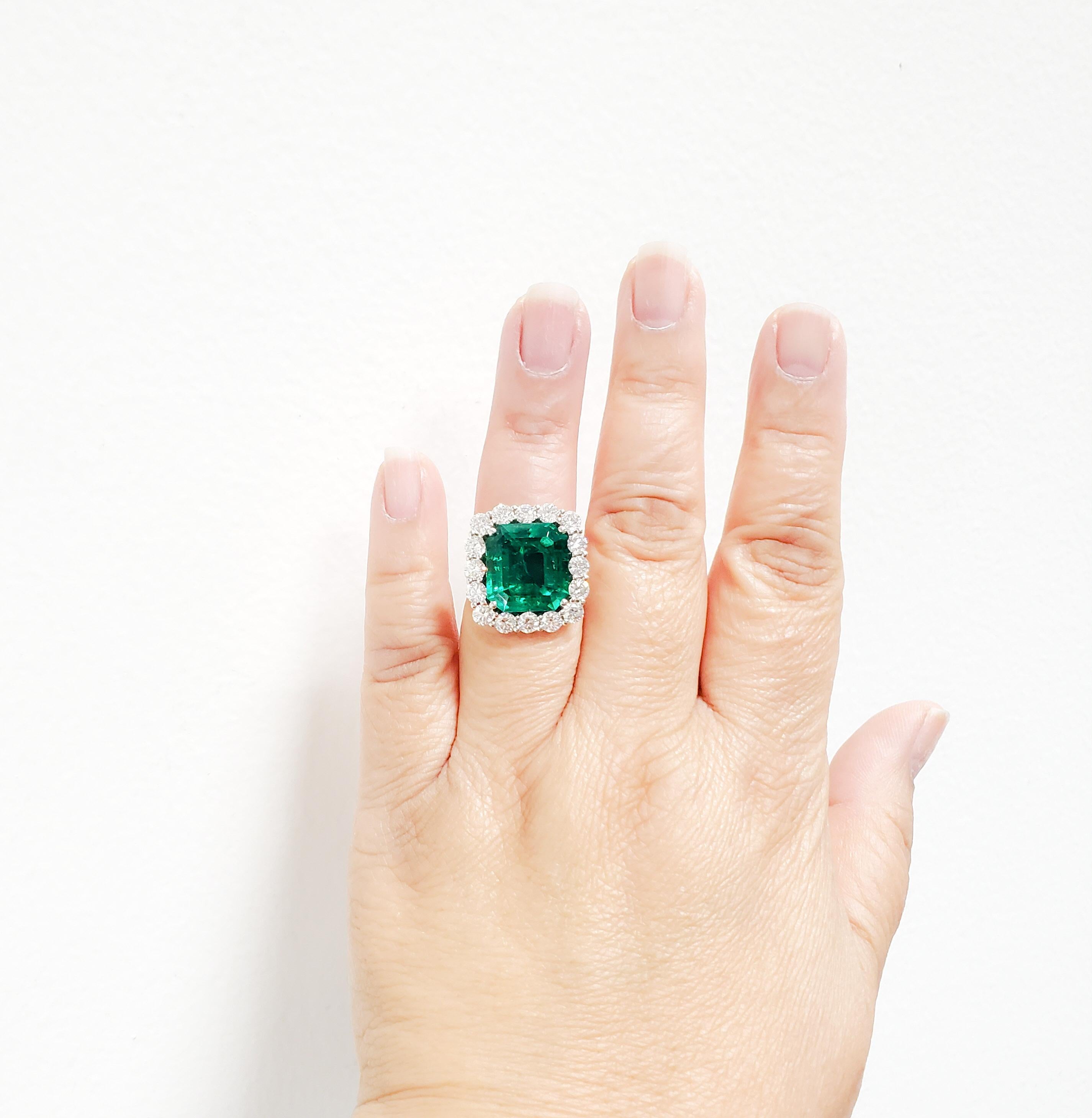 Absolutely stunning natural 11.02 ct. Colombian emerald emerald cut with 2.59 ct. excellent quality white diamond rounds.  Handmade in platinum.  Ring size 6.25.  AGL certificate included.