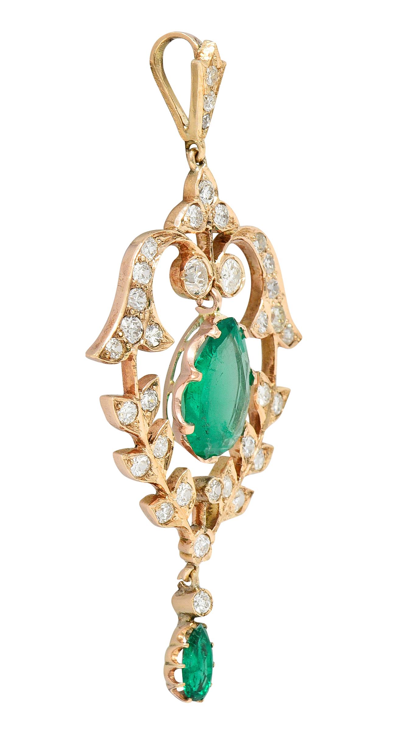 Designed as a lavalier style foliate motif pendant centering an articulating pear cut emerald drop. Natural Colombian in origin with minor traditional clarity enhancement. Prong set and weighing 2.83 carats total - transparent bright green in color.