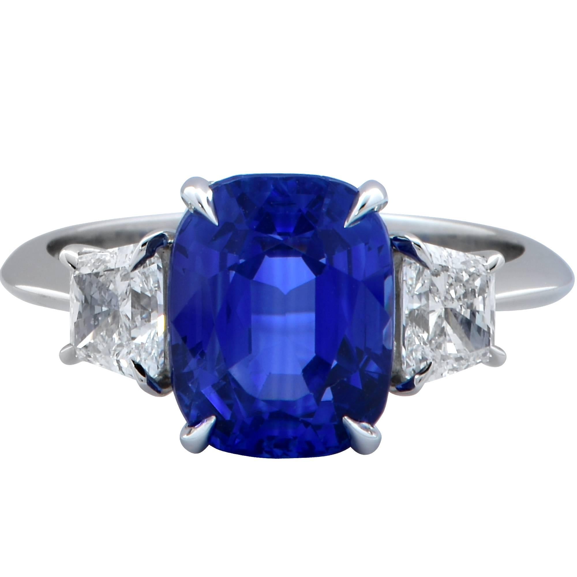 This gorgeous three-stone platinum ring features an AGL graded 4.85ct Cyelon no heat sapphire and is accented by two trapezoid cut diamonds weighing .81cts G color VS clarity.

The ring is a size 6 and can be sized up or down.
Measurements are