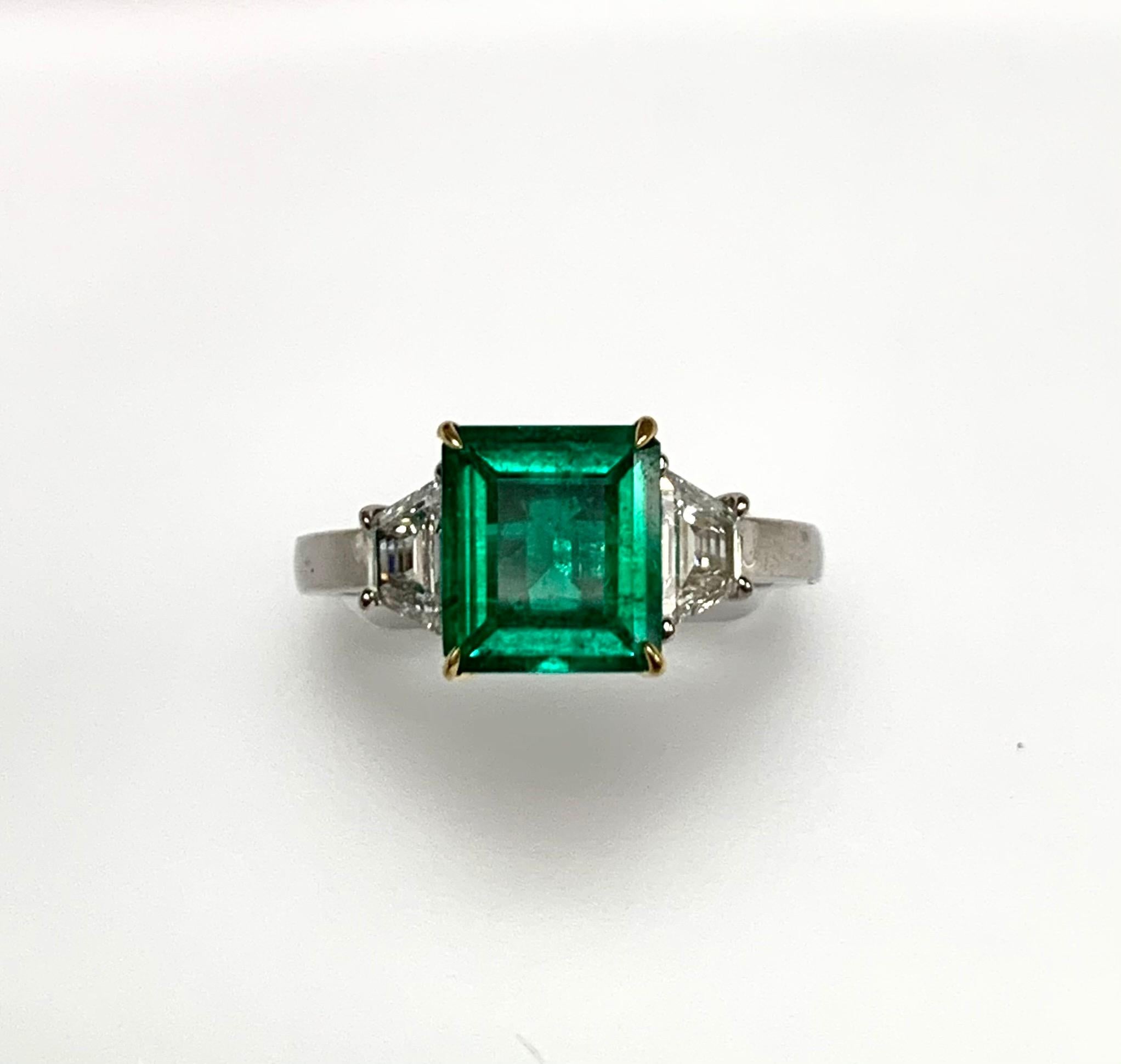 1.85 carat emerald cut Colombian emerald certified by AGL lab set in hand made platinum ring along with 0.60 ct G-h si1 Trapezoid diamonds .