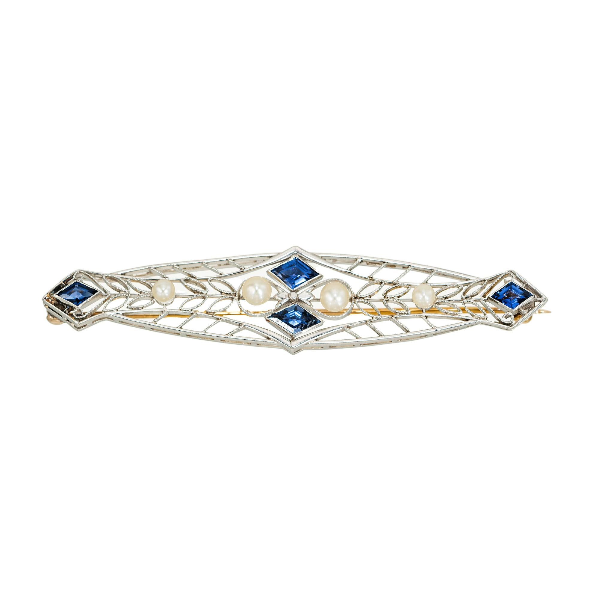 Natural no heat Yogo Gulch Montana Sapphires, circa 1910. Four rare Art Deco kite shaped AGL certified natural, no heat Sapphires mounted on a platinum setting and accented with 4 natural pearls. The brooch is hand made in Platinum with a 14k yellow