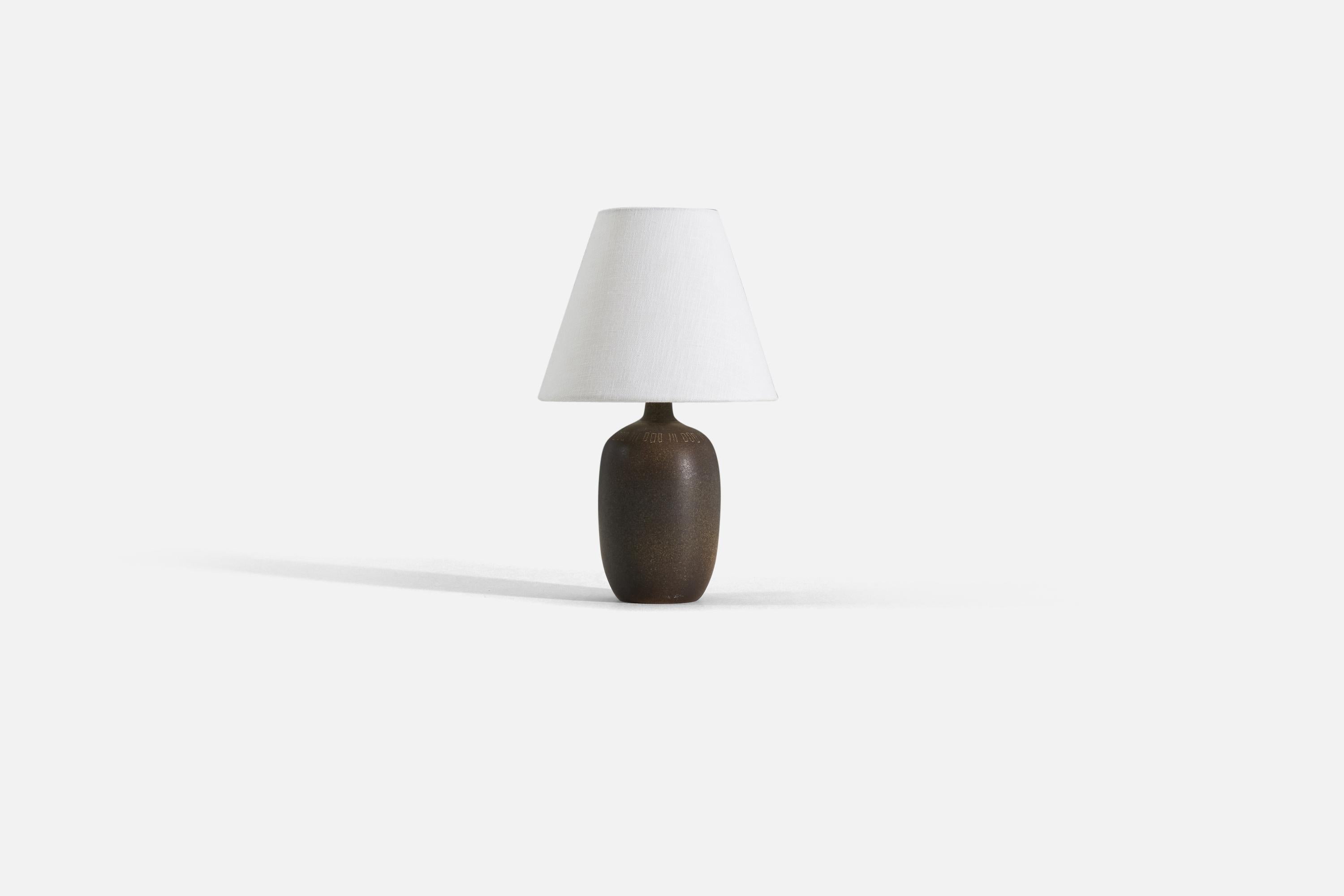 A brown-glazed and incised stoneware table lamp designed and produced by Agne Aronson, Sweden, in the 1960s.

Sold without lampshade. 

Measurements listed are of lamp.
For reference. 
Shade : 4 x 8 x 6.75
Lamp with shade : 13 x 8 x 8.