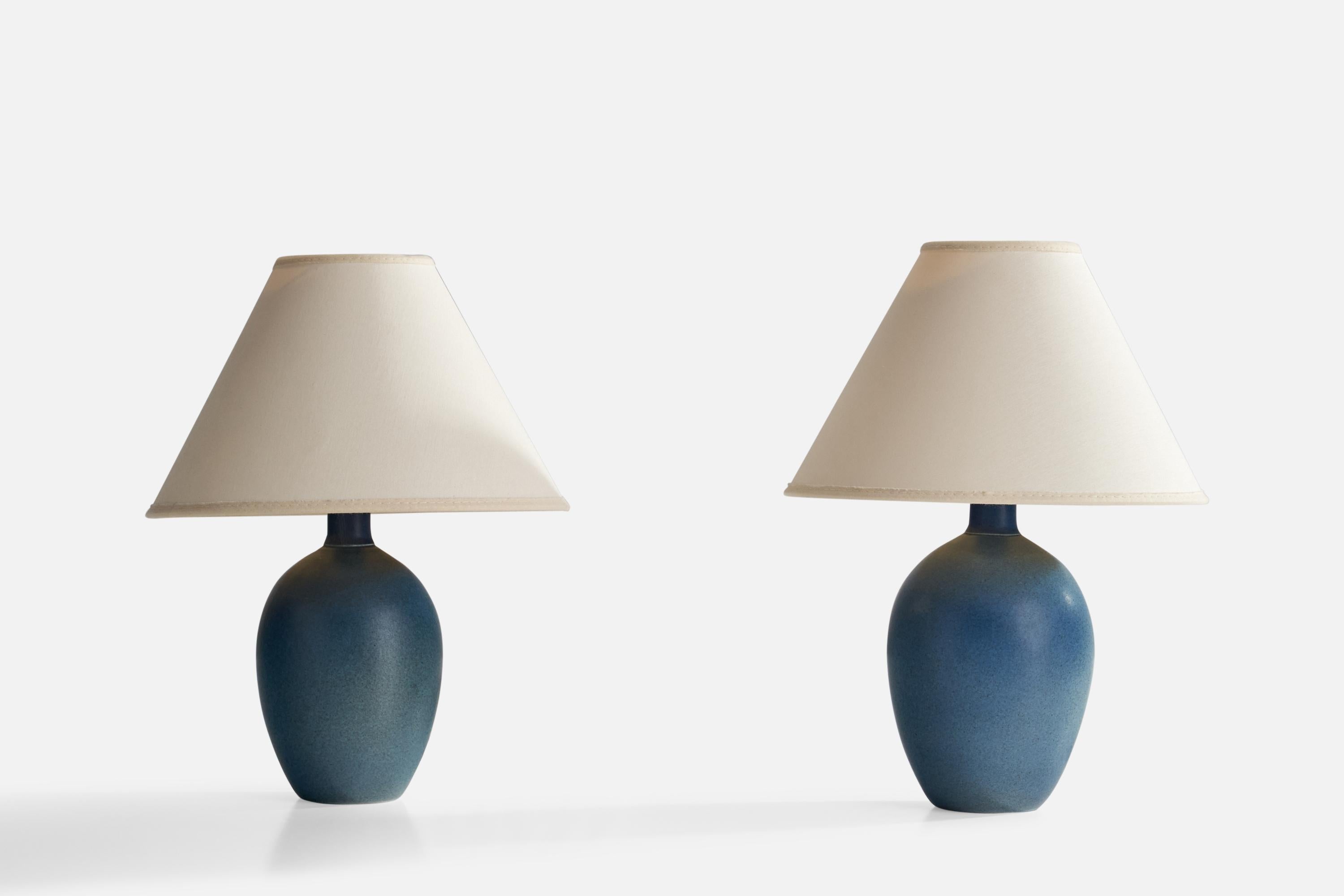 A pair of blue-glazed stoneware and off-white fabric table lamps designed and produced in Sweden, 1970s.

Overall Dimensions (inches): 8.25”  H x 4” D
Stated dimensions include shade.
Bulb Specifications: E-26 Bulb
Number of Sockets: 2
All lighting