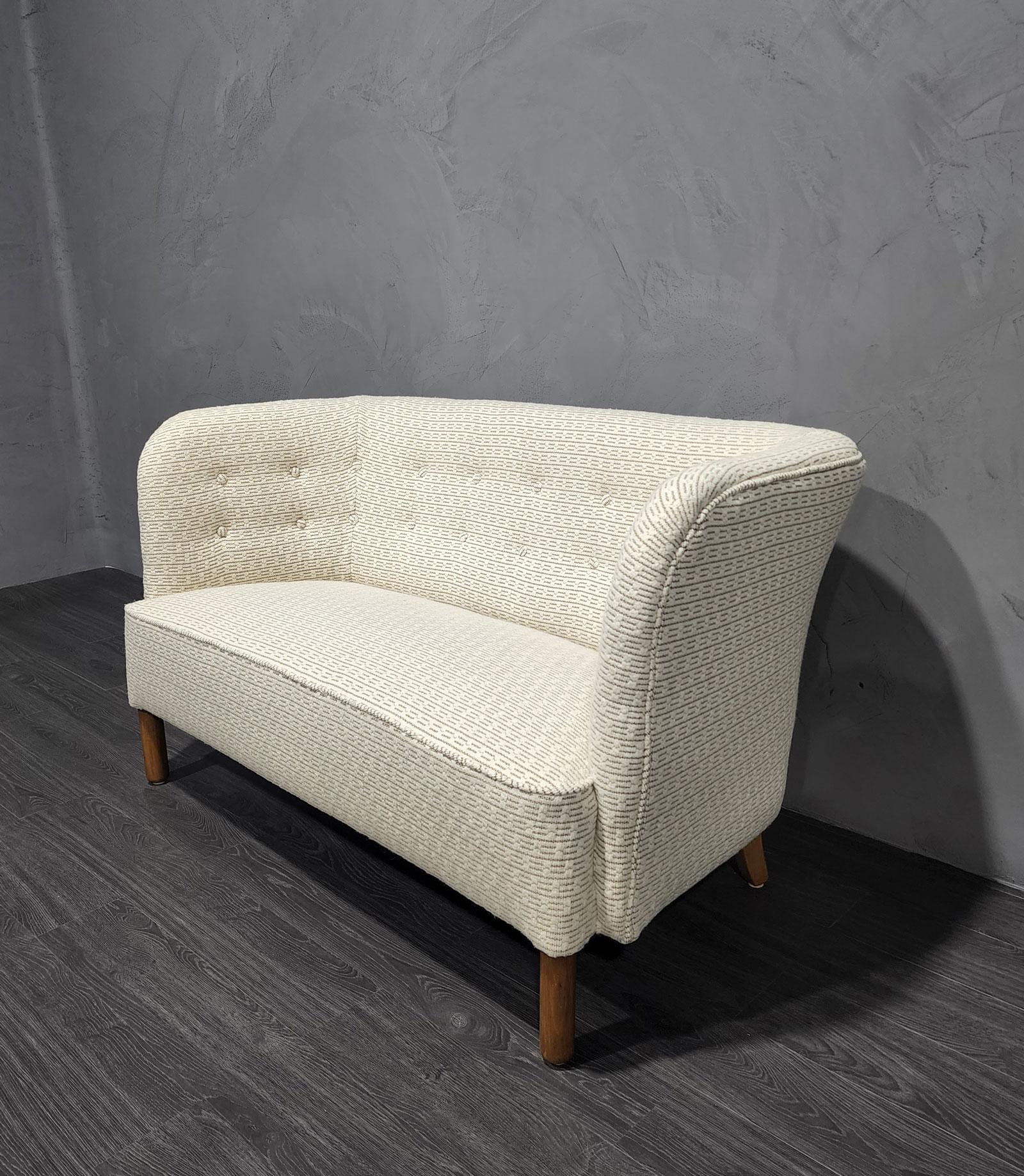 We have reupholstered this beautiful high quality settee designed by Agner Christoffersen in a rich textured Kelly Wearstler fabric.