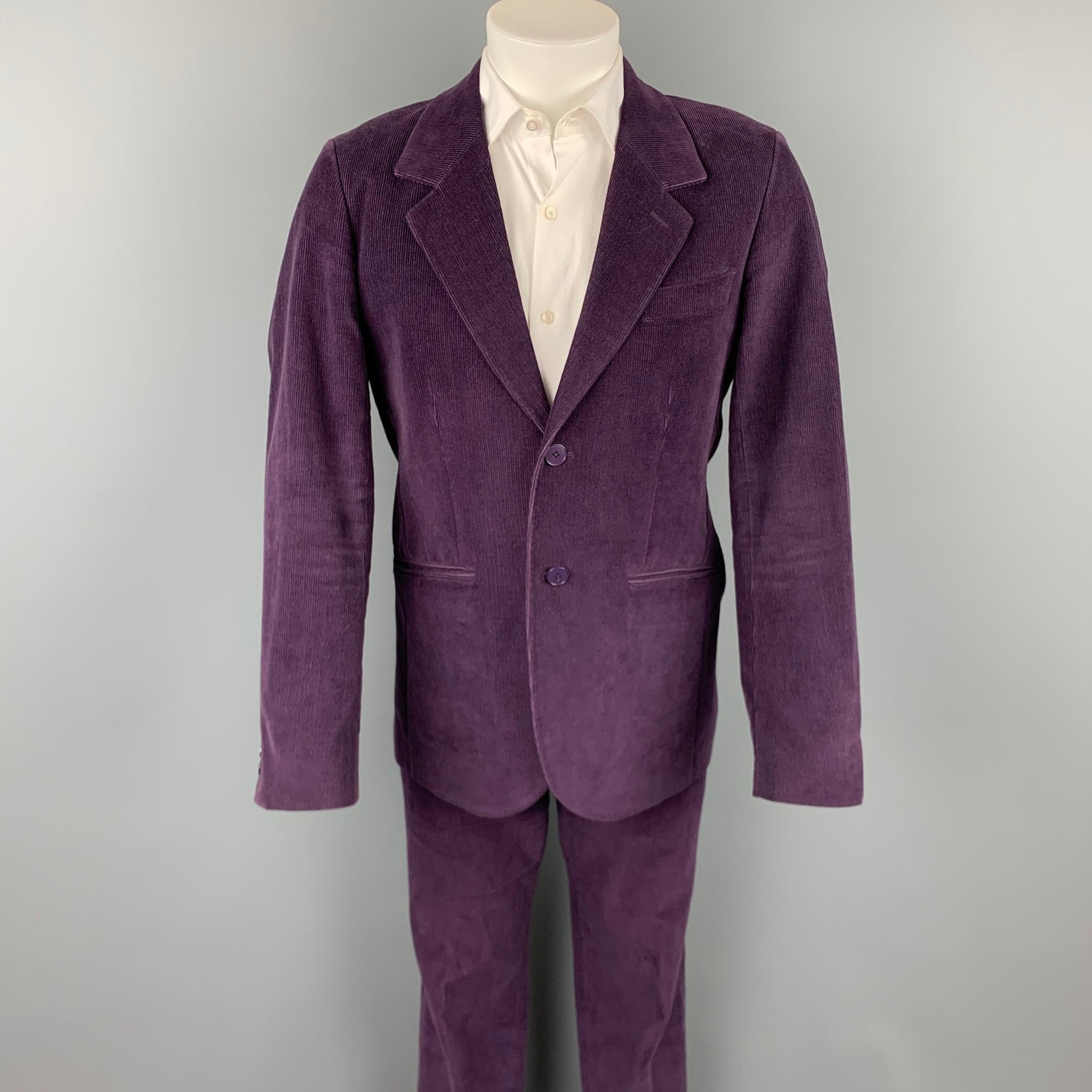AGNES B. suit comes in a purple cotton corduroy with a full liner and includes a single breasted, two button sport coat with a notch lapel and matching flat front trousers. Made in France.

Very Good Pre-Owned Condition.
Marked: FR