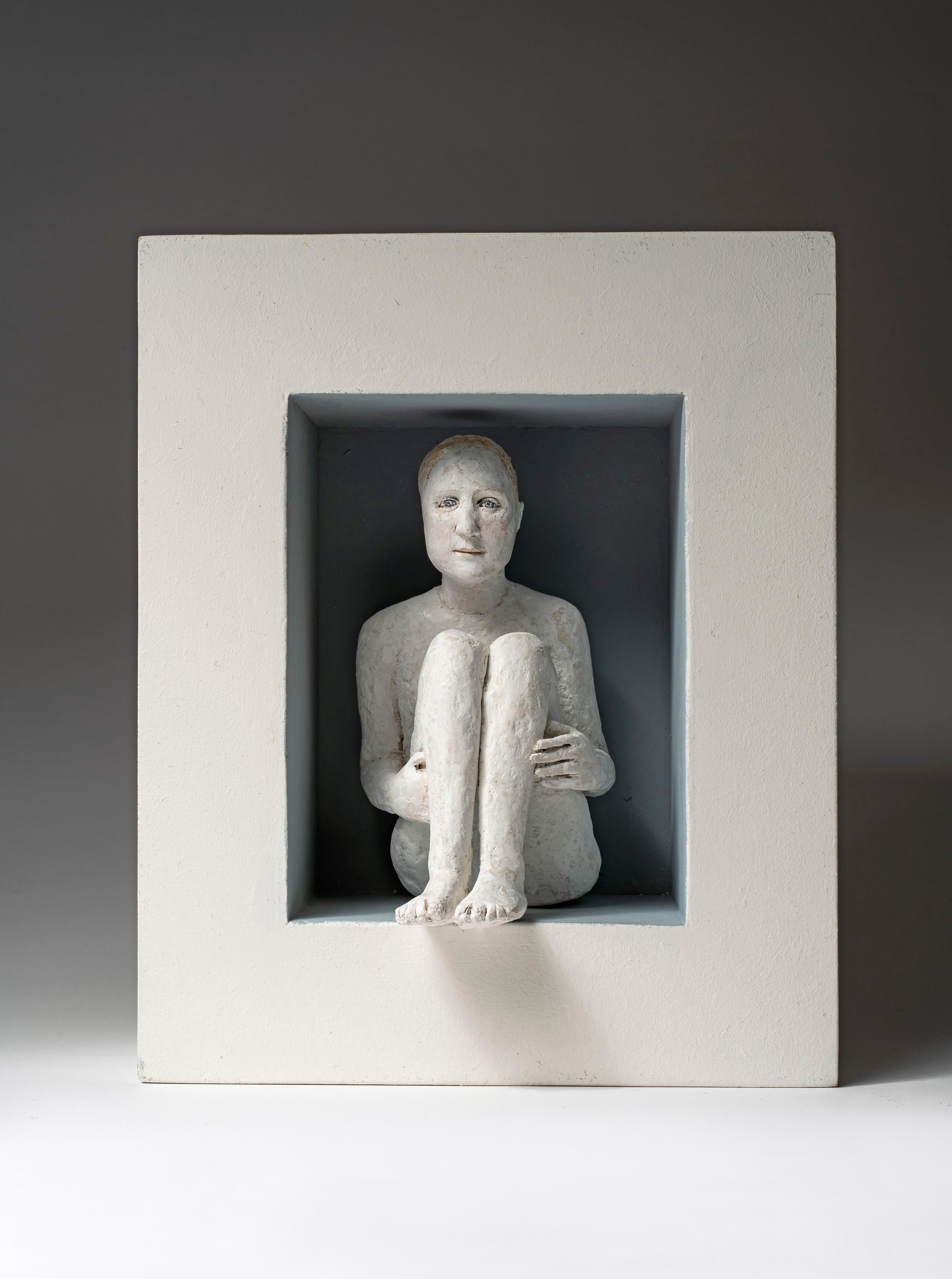 Agnes Baillon Figurative Sculpture - Wall sculpture of seated figure in box frame: Garcon sage dans une boîte