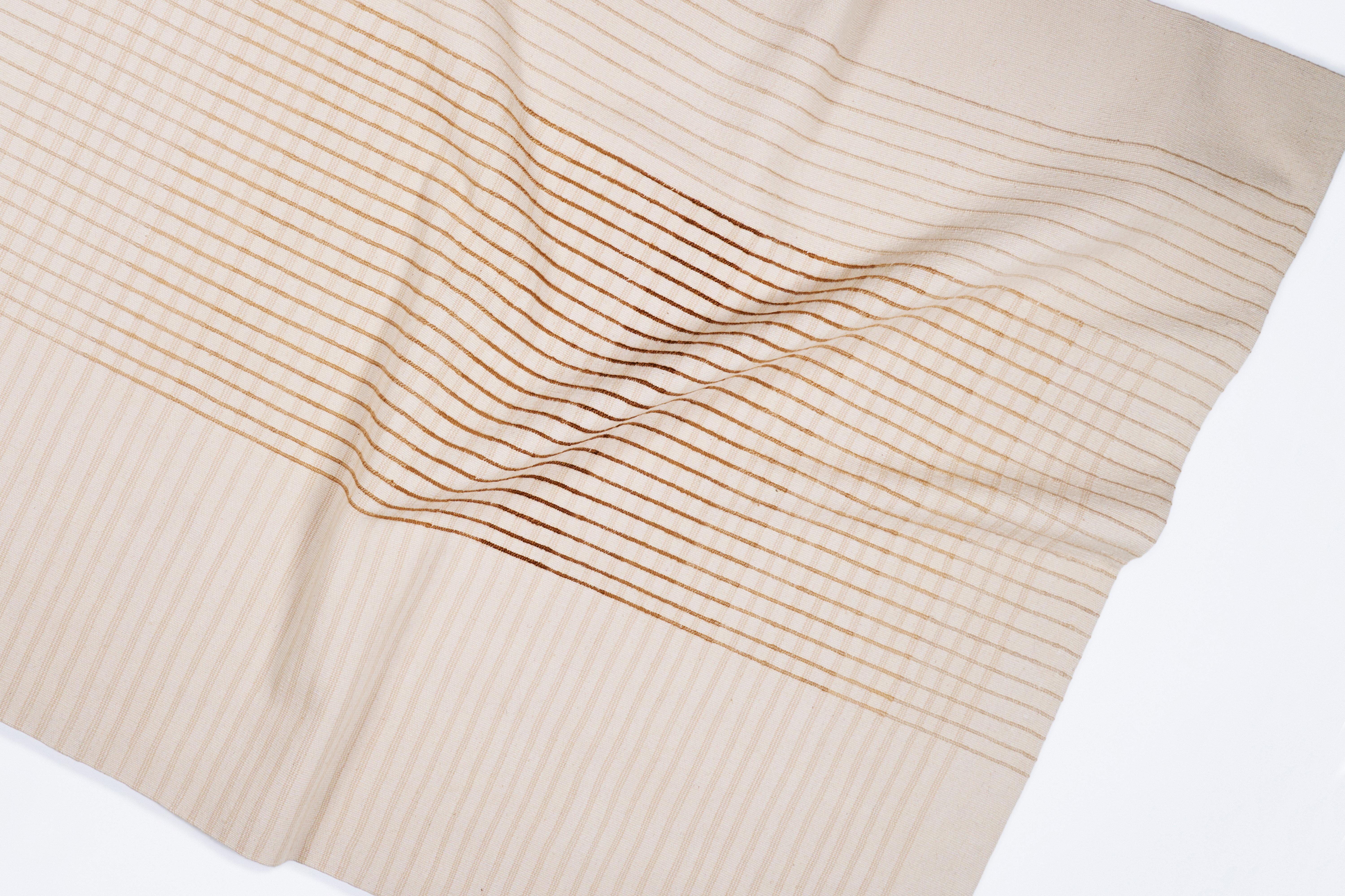Inspired by Agnes Martin's delicate lines and the Japanese philosophy of Ma, AGNES contemporary handwoven area rug collection conveys a sense of simplicity and elegance. Its minimal design invites contemplation and serenity, a space for the mind to