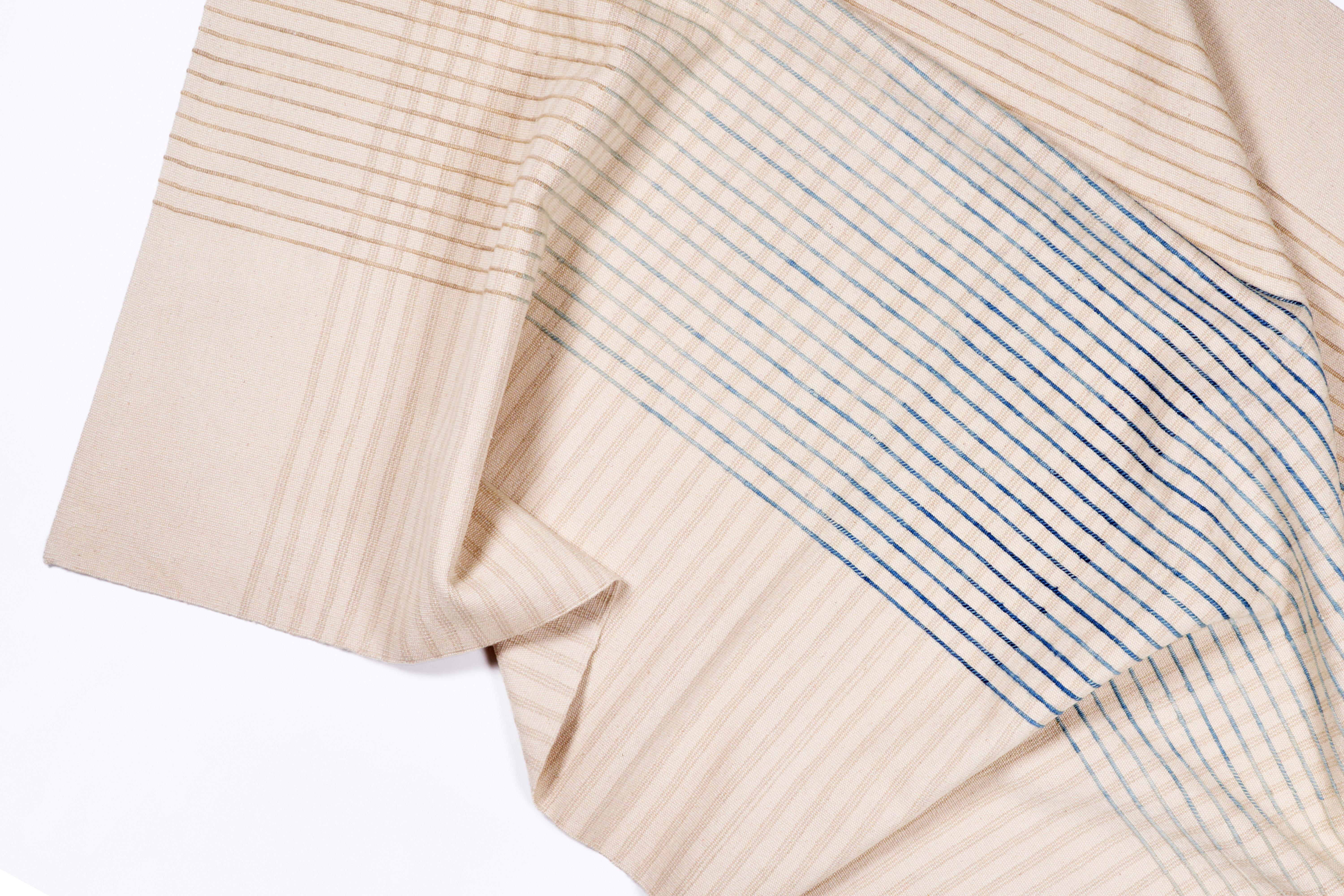 Inspired by Agnes Martin's delicate lines and the Japanese philosophy of Ma, AGNES contemporary handwoven area rug collection conveys a sense of simplicity and elegance. Its minimal design invites contemplation and serenity, a space for the mind to