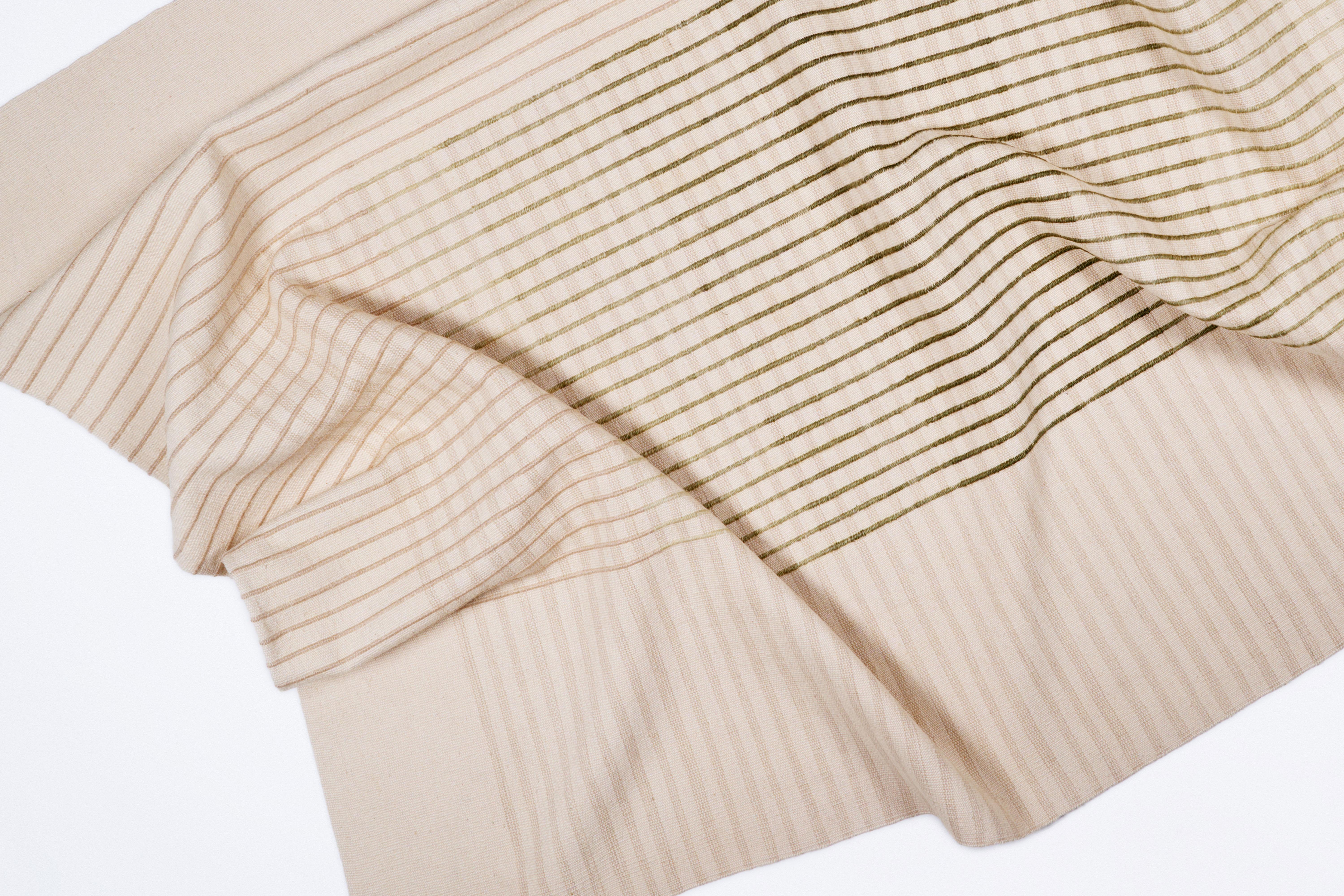 Inspired by Agnes Martin's delicate lines and the Japanese philosophy of Ma, AGNES contemporary handwoven area rug collection conveys a sense of simplicity and elegance. Its minimal design invites contemplation and serenity, a space for the mind to
