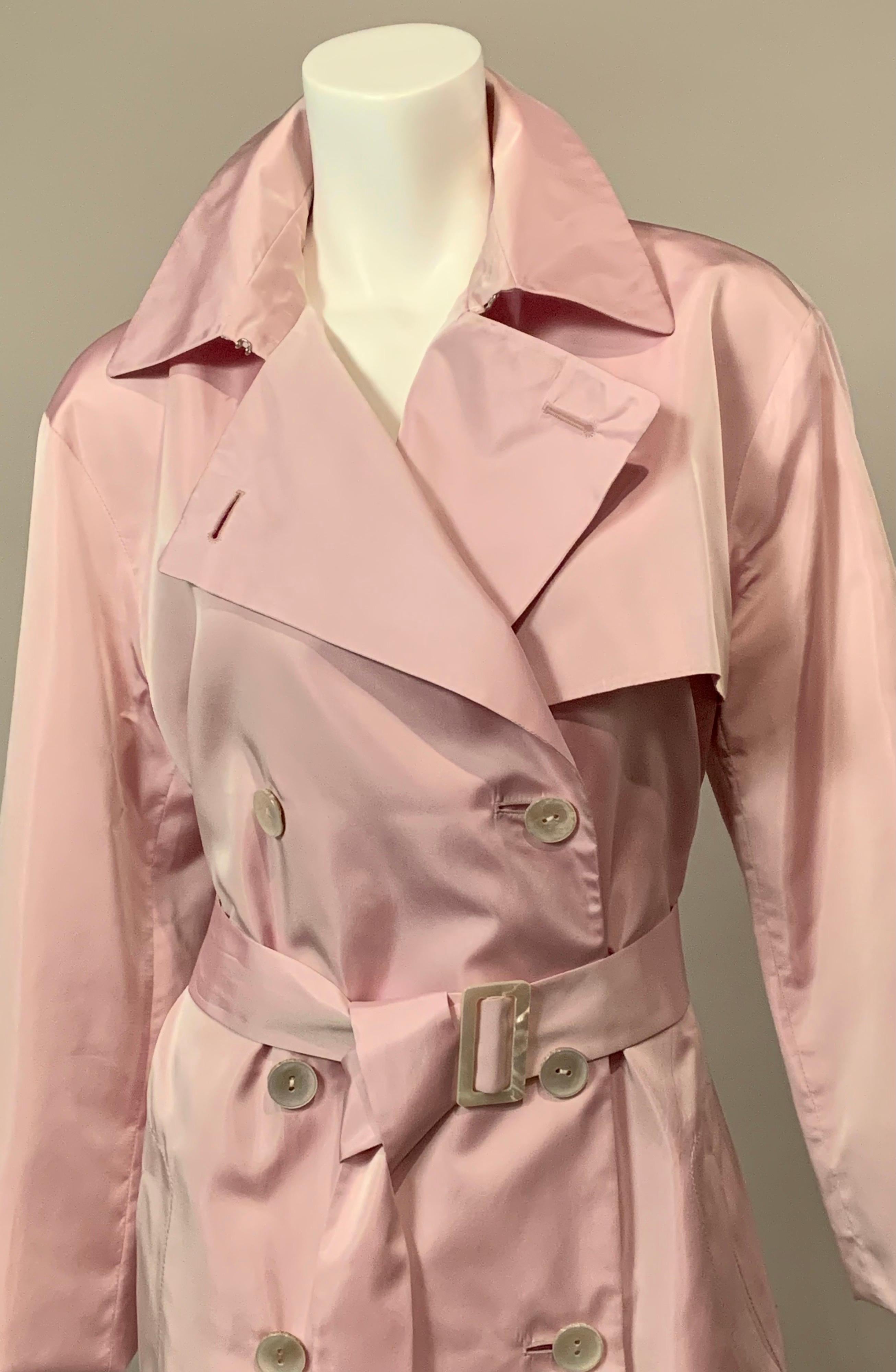 This is such a pretty and feminine coat from Agnona.  It is 100% silk in a beautiful shade of lavender with Mother of Pearl buttons and belt buckle. The coat has all of the details of a classic double breasted trench coat but this one could do
