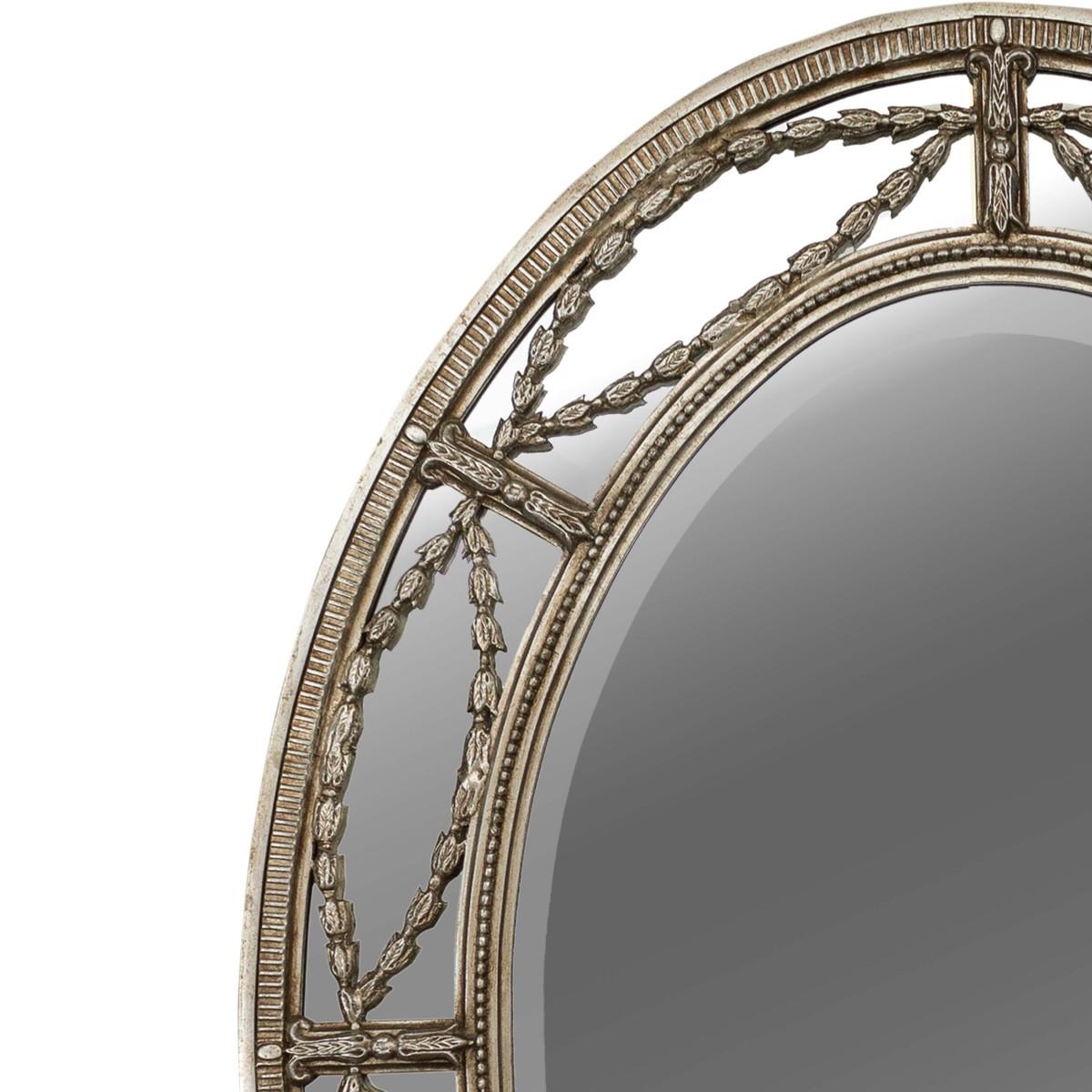 Silver gilt beveled oval mirror made by Agostino Antiques.

Features an oval frame with a garland overlay and beveled mirrors within.
     