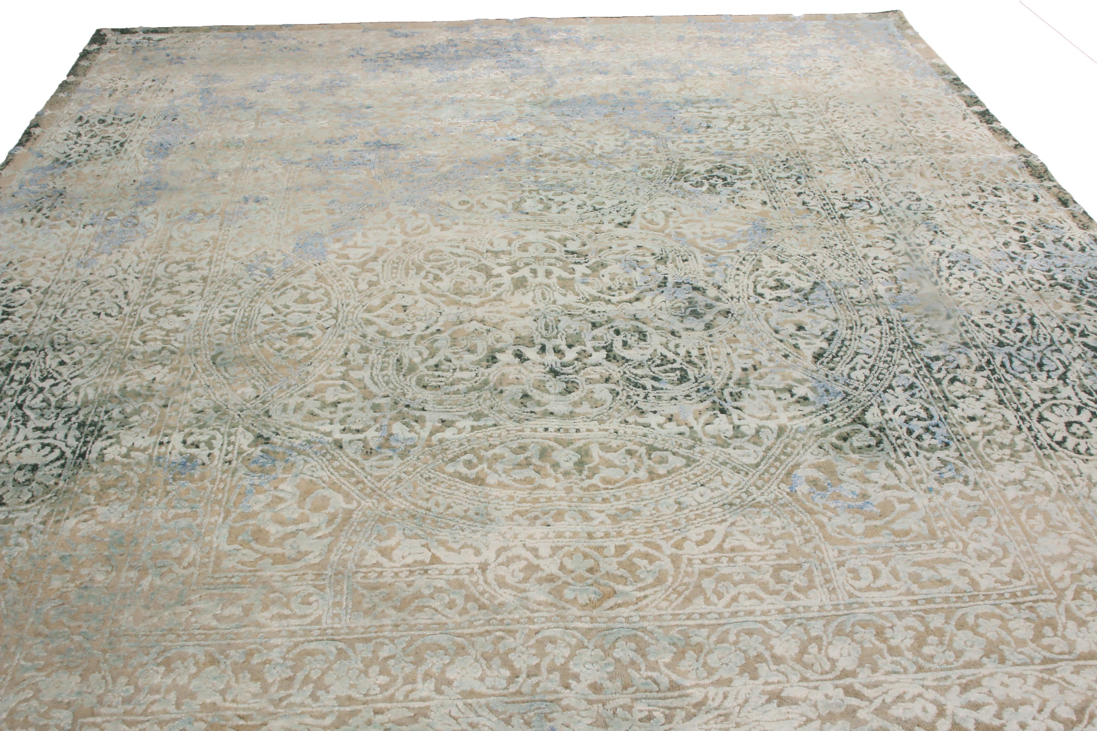 Originating from India, this Agra geometric-floral rug is hand knotted in high-quality wool and silk with distinguished colorways and a unique combination of patterns. Featuring an all-over field design marrying Frost blue and a distinct green-gray