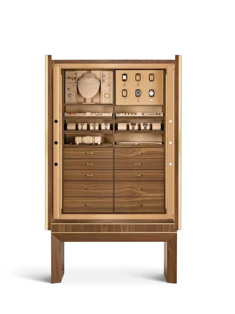Contemporary armored jewelry and watch armoire in matte Canaletto walnut and 24-karat gold-plated hardware. Inside, safe with biometric opening device. Drawers and pull-out trays lined for jewelry. Six watch winders made in Switzerland and secret
