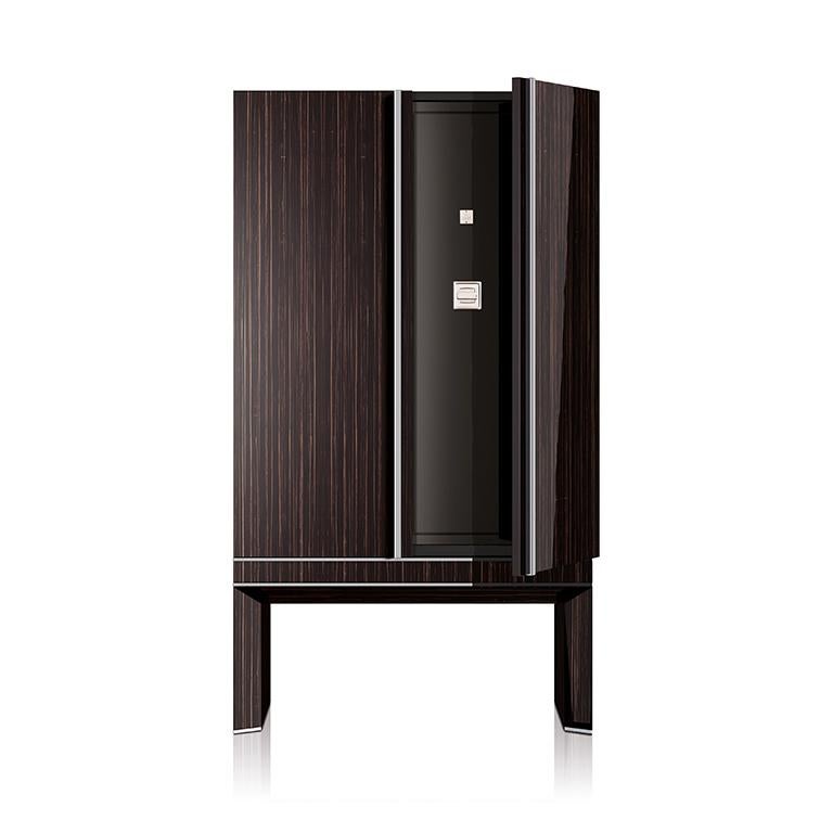 Armored armoire in polished ebony, brass accessories in Ruthenium. Safe with biometric opening device, drawers and trays lined for watches and jewelry. Available with 18 Swiss made watch winders. Two secret compartments. Safe to be anchored to the