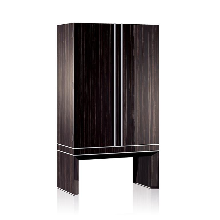 Armored armoire in polished ebony, brass accessories in ruthenium. Safe with biometric opening device, drawers and trays lined for watches and jewelry. Available with 36 Swiss made watch winders. Two secret compartments. Safe to be anchored to the