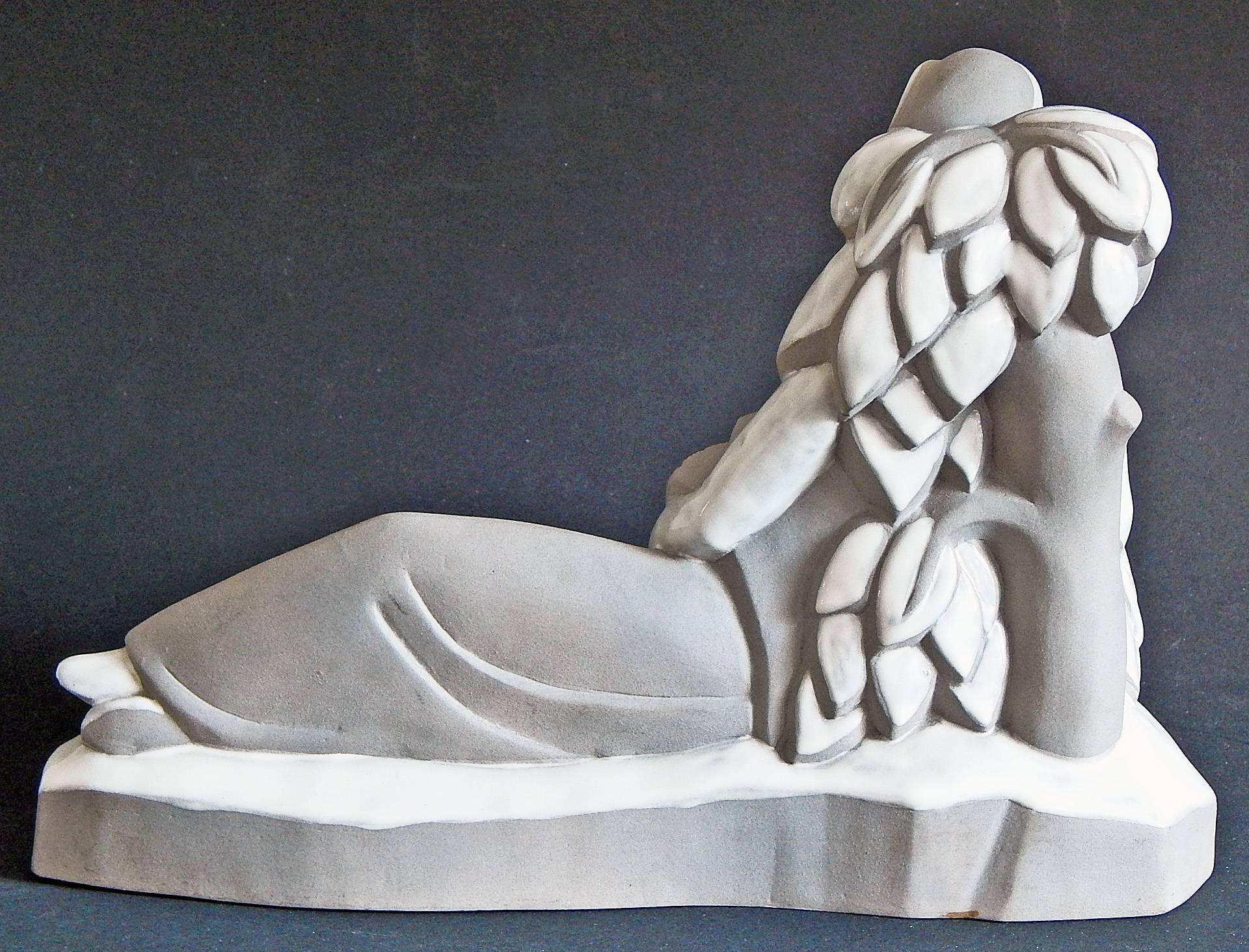 A striking example of the love of allegory among sculptors and painters in the Art Deco period, this rare piece depicts a stylized female figure holding a sheaf of wheat and scythe, resting from her labors for a moment in the fields. The sculptor