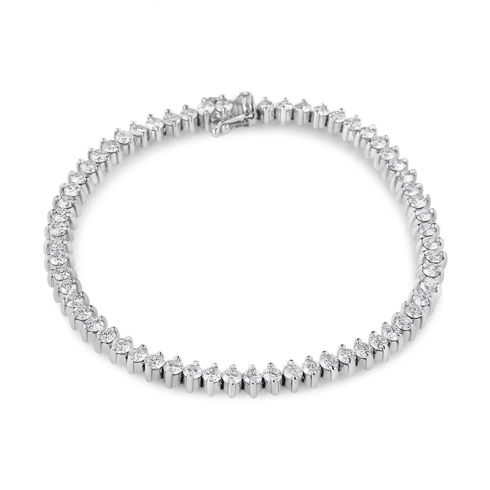 Bright and glamorous, this unique design brings an elegant touch to her jewelry wardrobe. Crafted from luxurious 14K white gold, this bracelet features a series of 2 prong links masterfully set with shimmering large diamonds and arranged in an