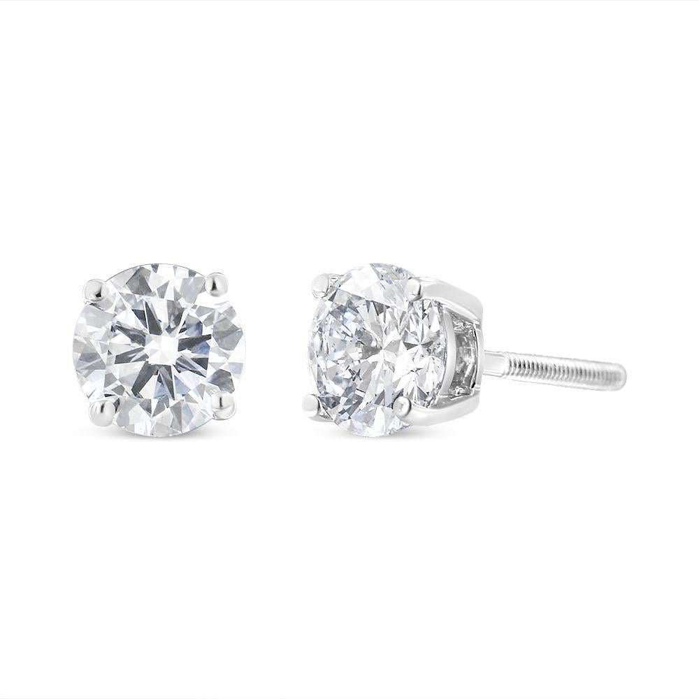 A classic pair of solitaire diamonds earrings, each with a single round brilliant cut diamond set in a 4 prong, 14 karat white gold basket. These AGS certified earrings have screw backs. They are a perfect choice for a piece of jewelry to last a