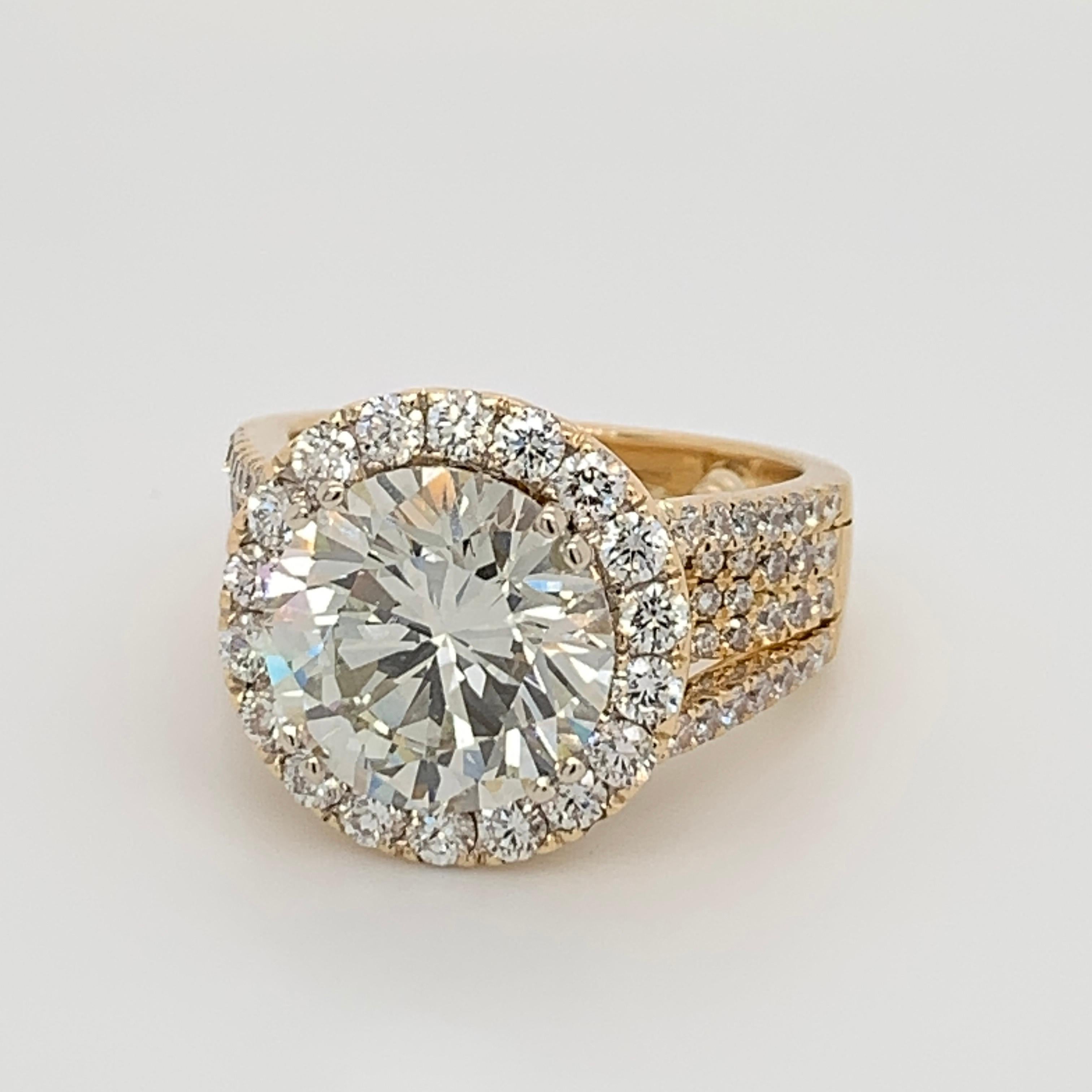 Stunning 18k Yellow Gold Natural Diamond Ring. The centerstone is a certified 5.11ct Round Brilliant diamond AGS certified as a K SI2. The nature of the inclusions are extremely pleasant (on the side, very clean looking). 

The mounting is set with