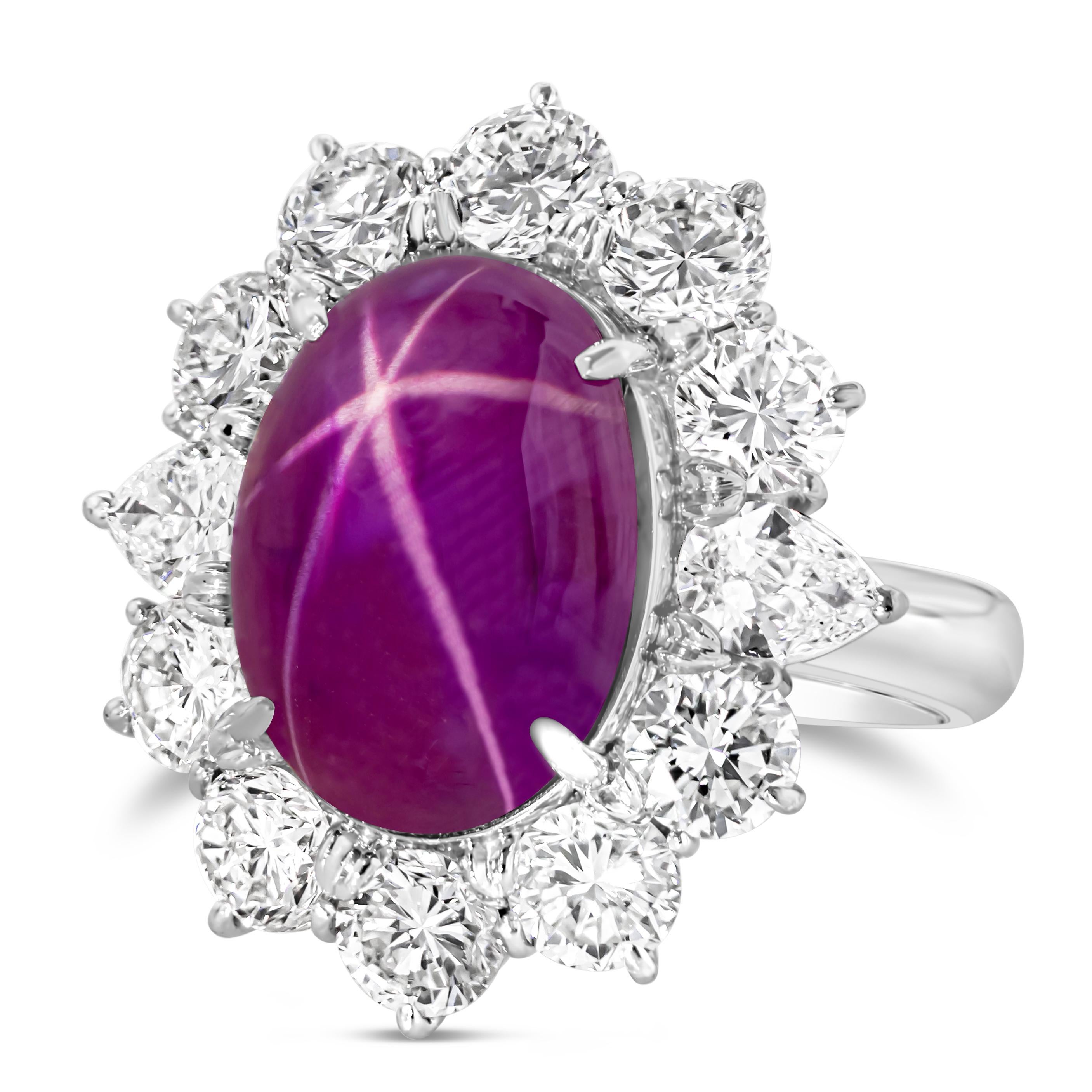 An exquisite cocktail ring, featuring a very rare 11.03 carats natural cabochon star ruby certified by AGTA as having a Burmese origin with a red color and no indication of heat treatment, set on a four prong setting. Surrounded by a halo of round