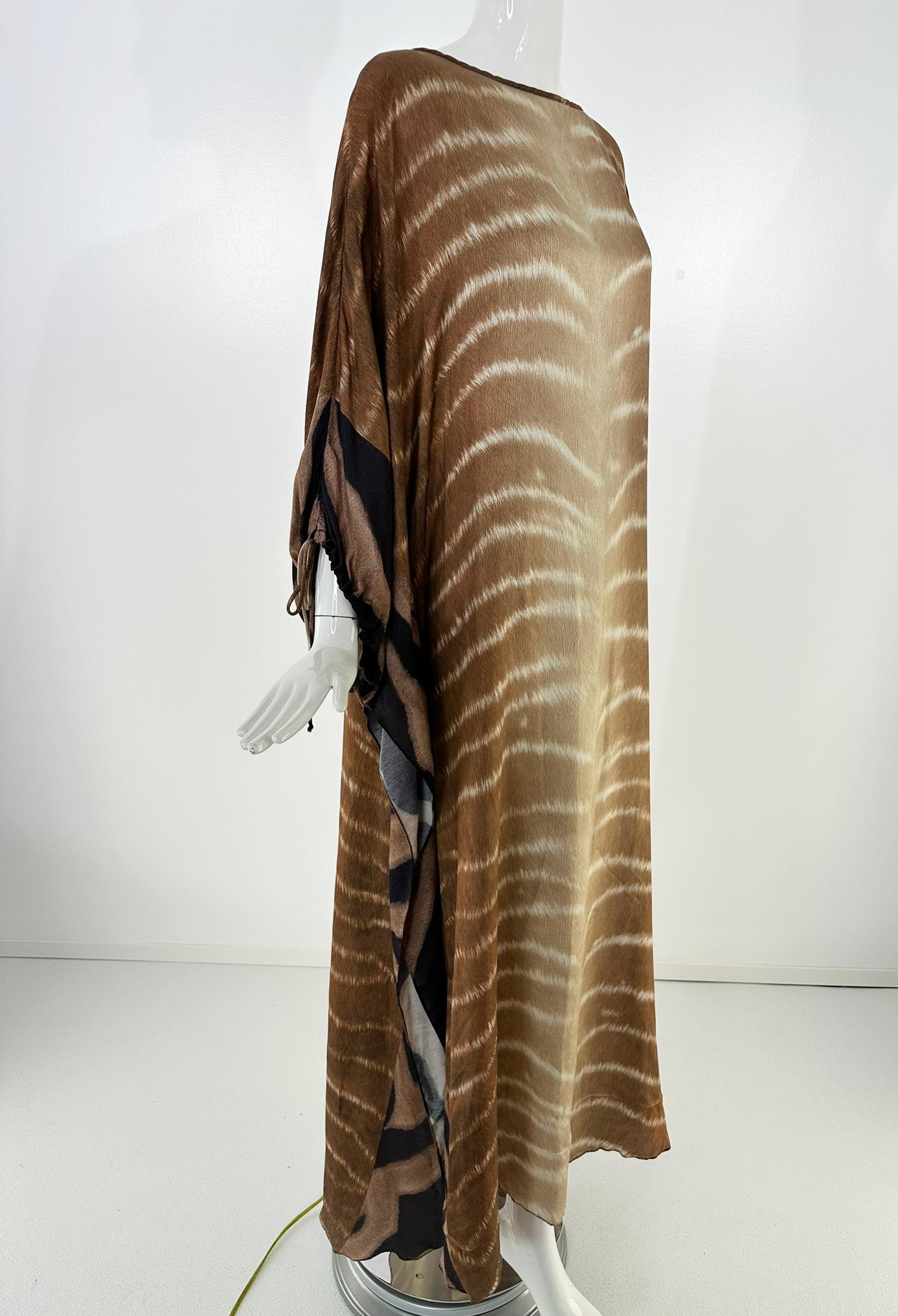 Aqua de Coco zebra print caftan in brown & cream silk/rayon blend fabric. Long flowing caftan with a boat neck, the side panels are darker brown in a coordinating design, they drape and tie at the wrists. The hem is longer in the back and shorter in