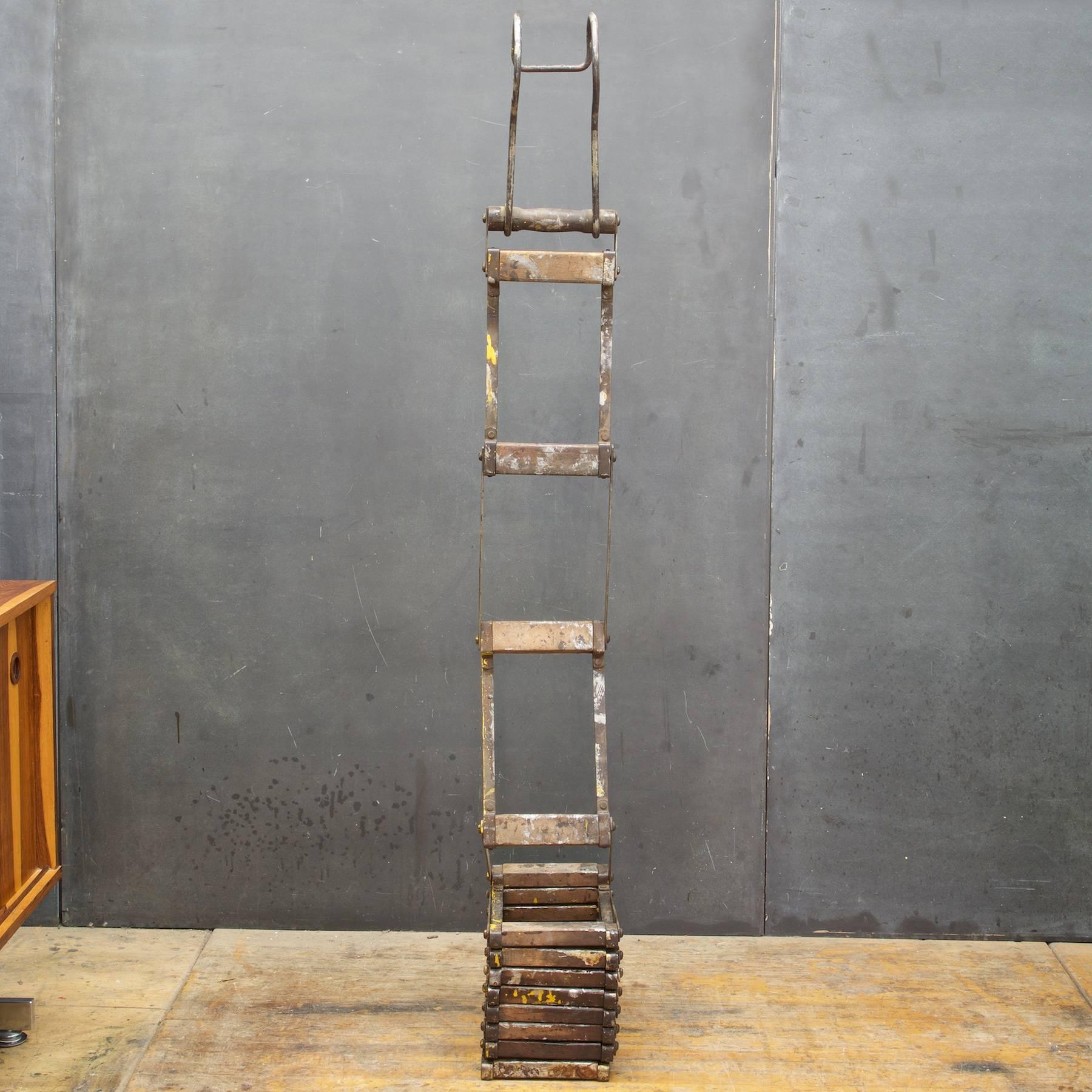 A vintage relic sold as a prop. An antique collapsible Early-century wooden and steel ladder. Each Rung Segment is 14 inches and space between rungs is about 12 inches.  Seems strong, the wood is not dry or weak, but I would seriously test this