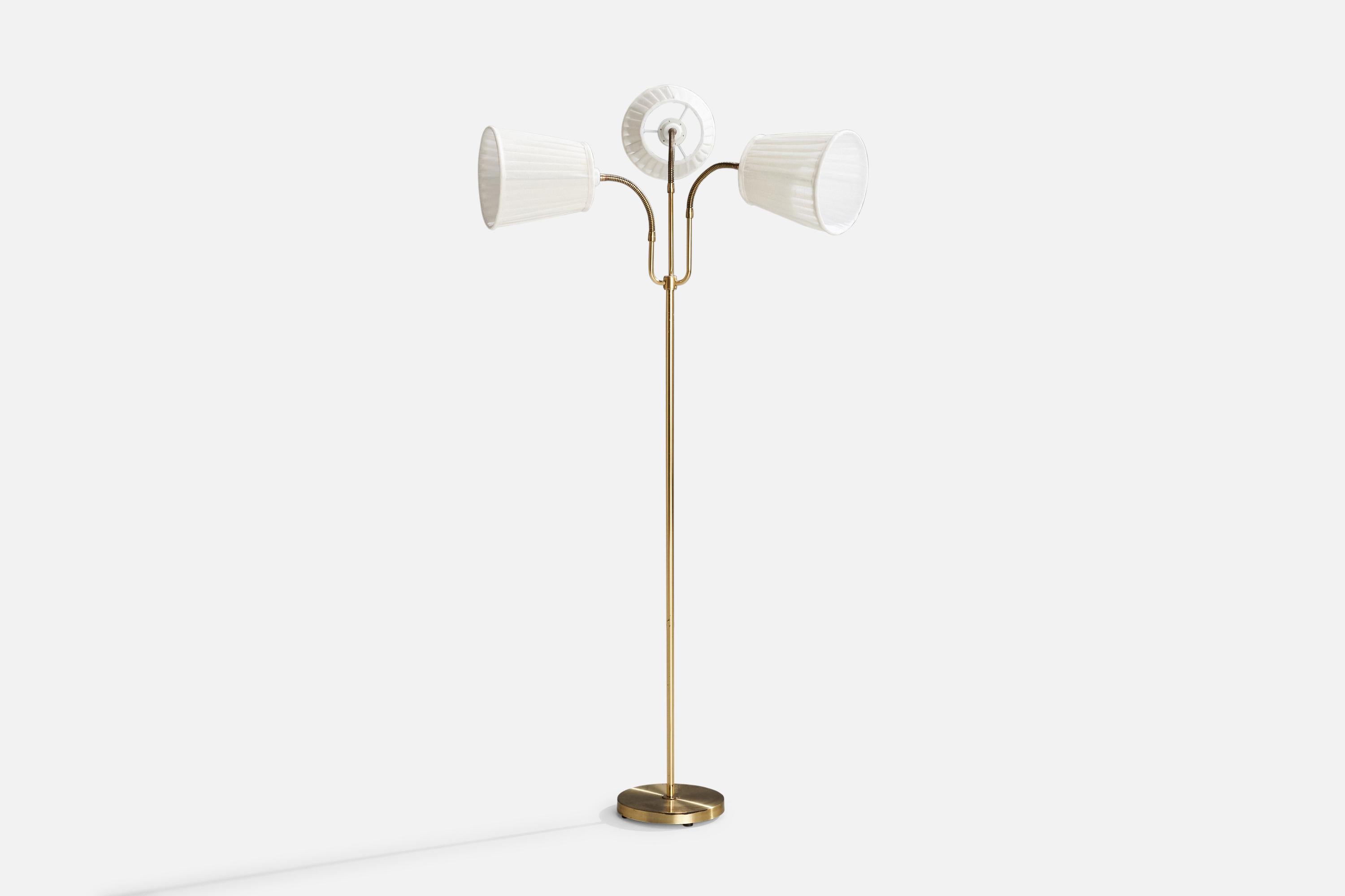 A brass and off-white fabric floor lamp designed and produced in Sweden, c. 1950s.

Dimensions Variable
Heavy oxidation present.
Overall Dimensions (inches): 55” H x 32” W x 21.875” D
Stated dimensions include shade.
Bulb Specifications: E-26