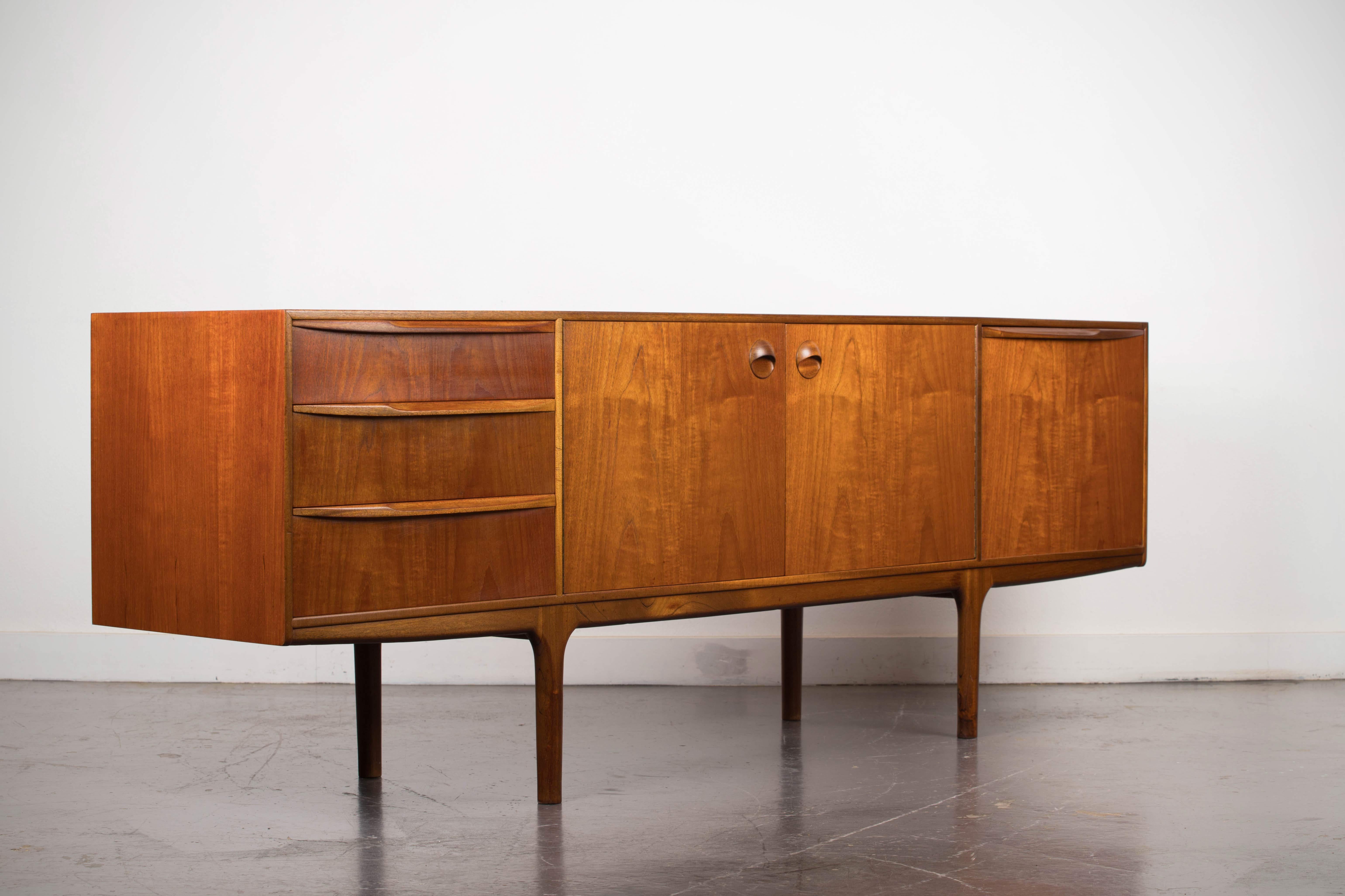 Stunning and beautifully crafted teak sideboard designed by Tom Robertson and manufactured by A.H. McIntosh of Kirkaldy, Scotland, 1960s. 

A.H. McIntosh created quality furniture which catered to the tastes of progressive 1960s middle class